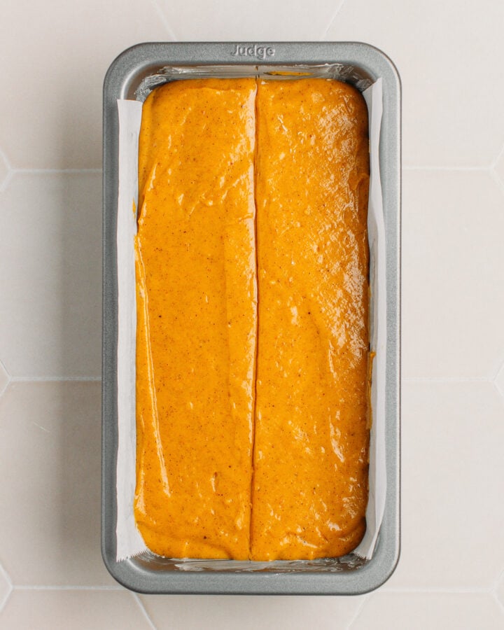 Pumpkin cake batter in a loaf pan.