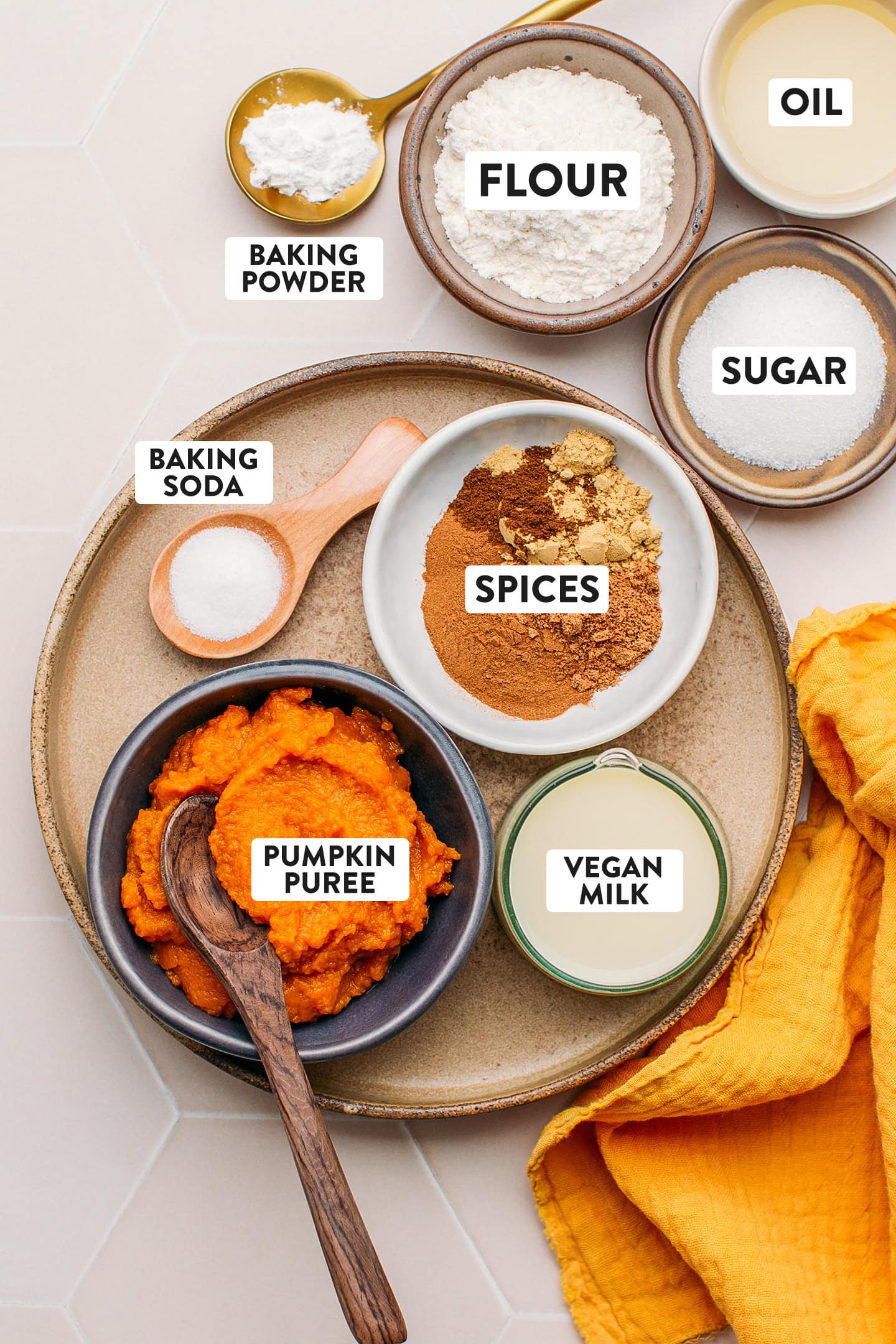 Ingredients like pumpkin puree, spices, sugar, oil, and plant-based milk.