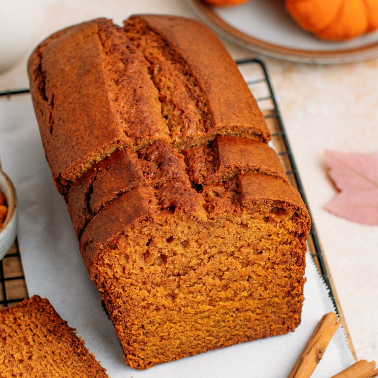 Sliced pumpkin bread on a cooling rack.