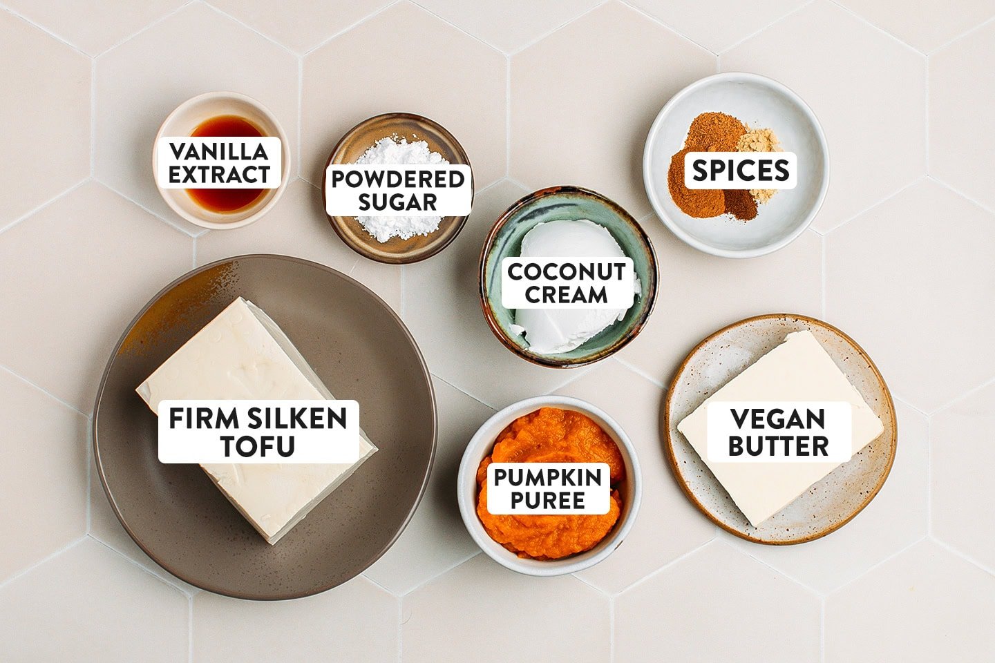Ingredients like firm silken tofu, pumpkin puree, vegan butter, and coconut cream.