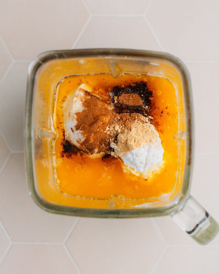 Pumpkin puree, coconut cream, silken tofu, and spices in a blender.
