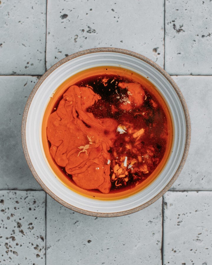 Chili oil, sesame paste, and soy sauce in a small bowl.