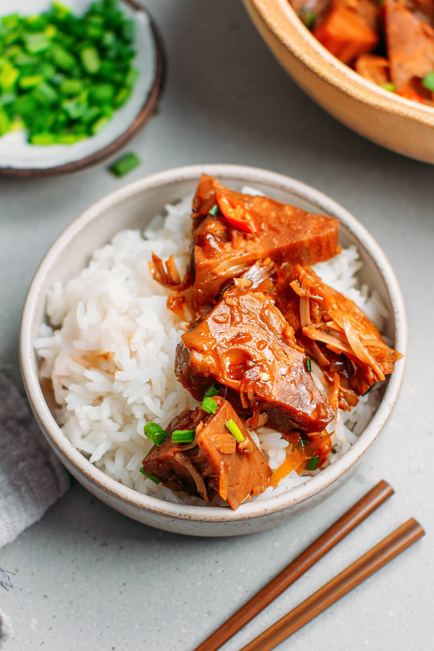 Juicy chunks of jackfruit over white rice in a bowl.