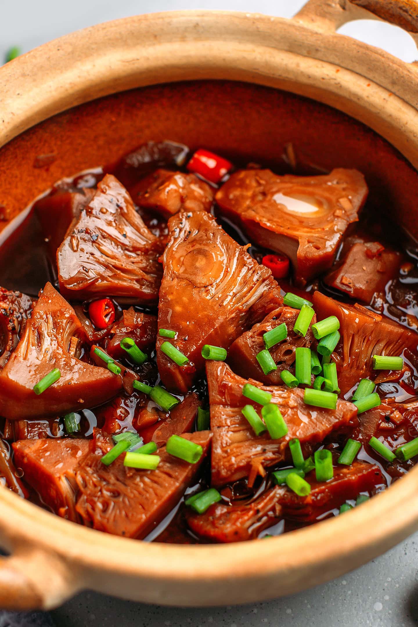 Close-up of jackfruit chunks in a sweet and salty black pepper sauce.