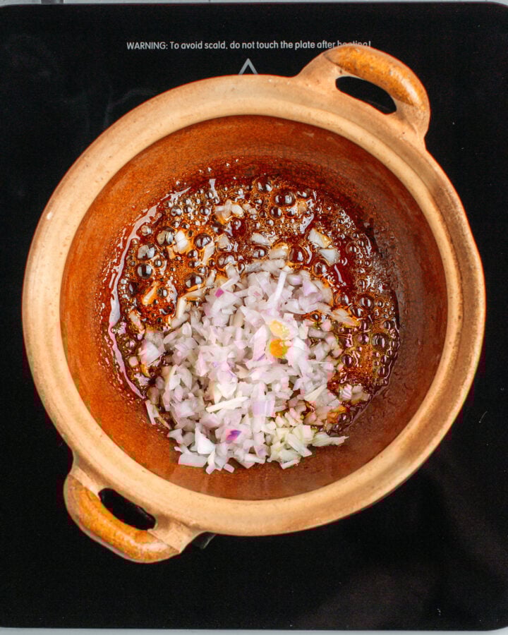 Minced shallots and caramel in a clay pot.