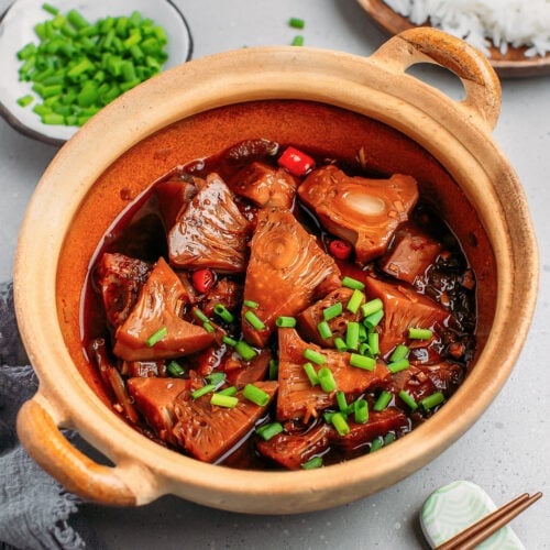 Braised jackfruit chunks in a clay pot.
