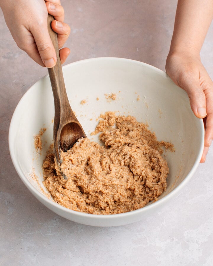 Mixing a cereal batter in a mixing bowl.