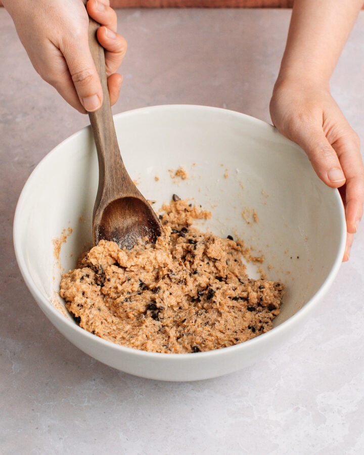 Mixing chocolate chip cereal batter in a mixing bowl.