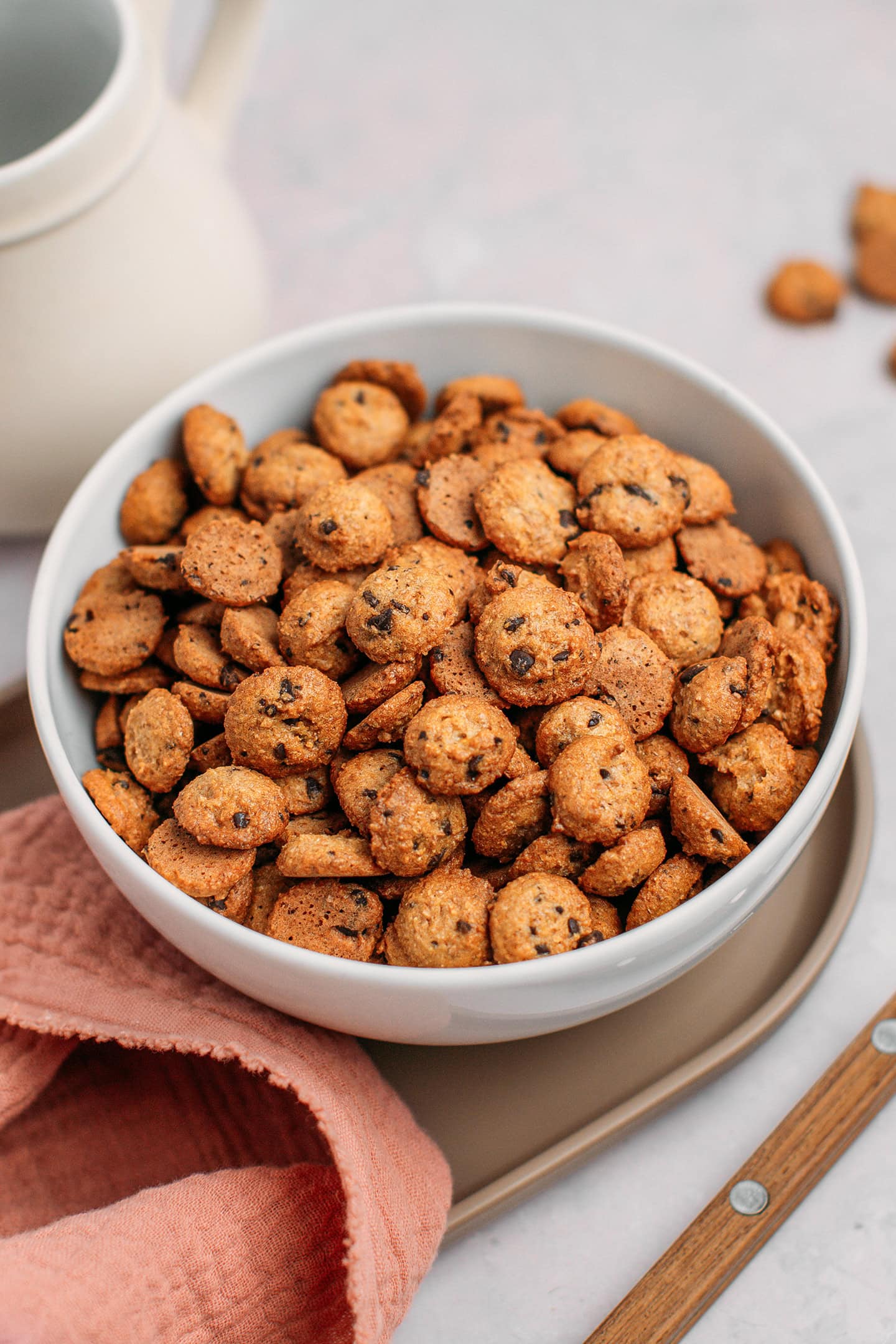 Mini chocolate chip cookies in a white bowl.