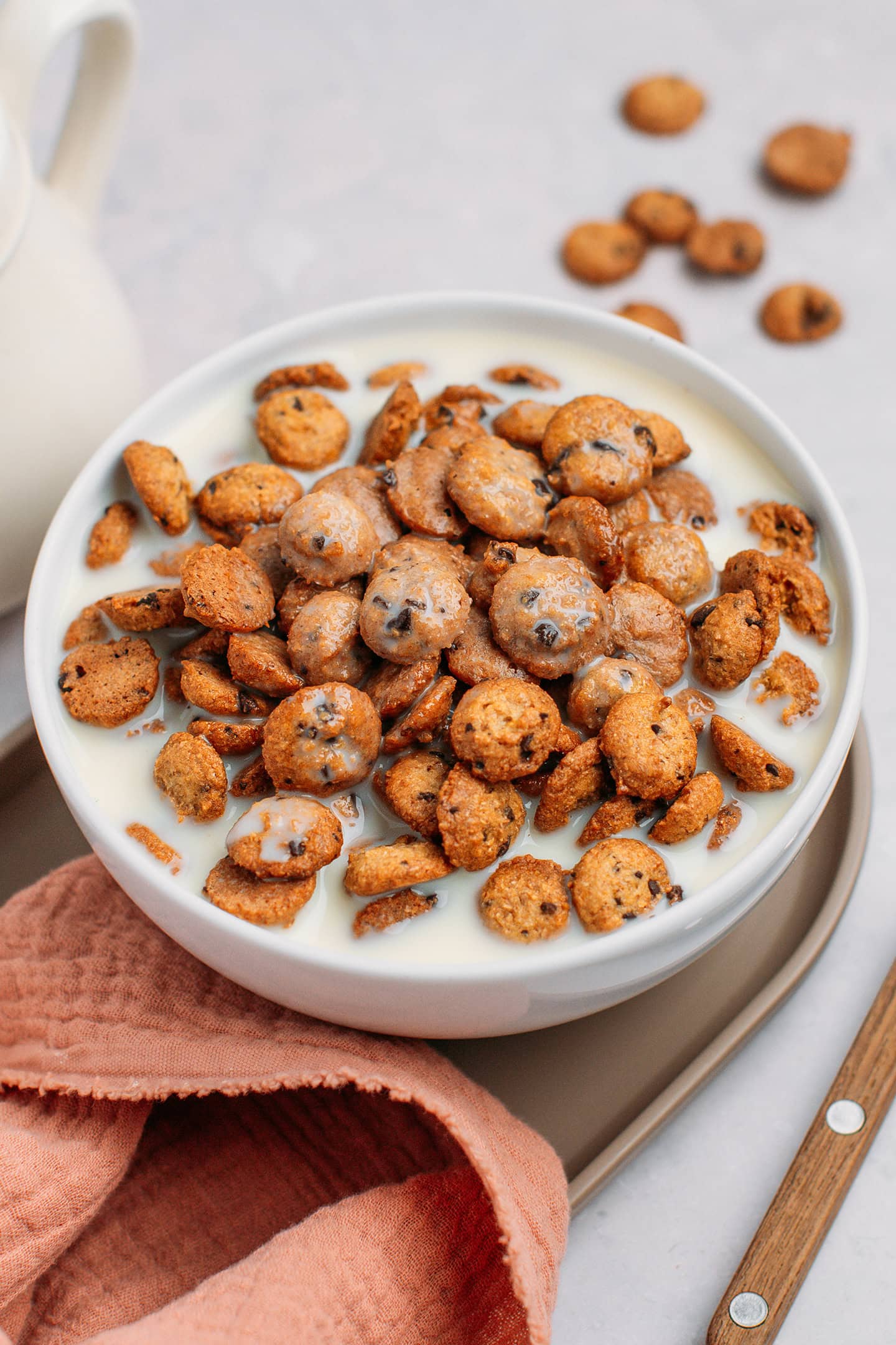 Bowl filled with milk and homemade cookie crisp cereal.