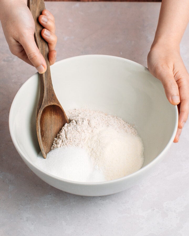Mixing flour, sugar, cornflour, and baking powder in a mixing bowl.