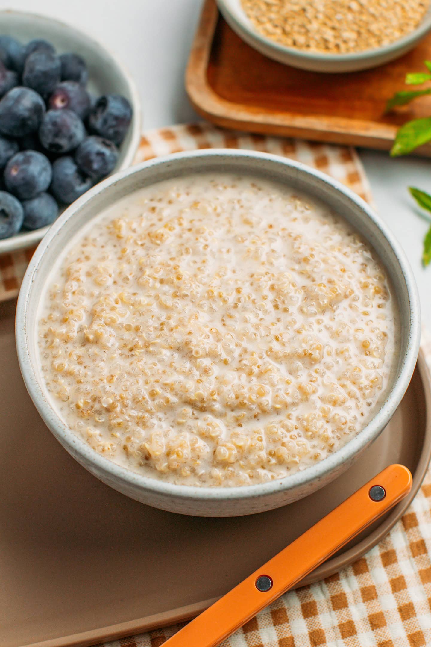 Ceramic bowl filled with creamy quinoa pudding.