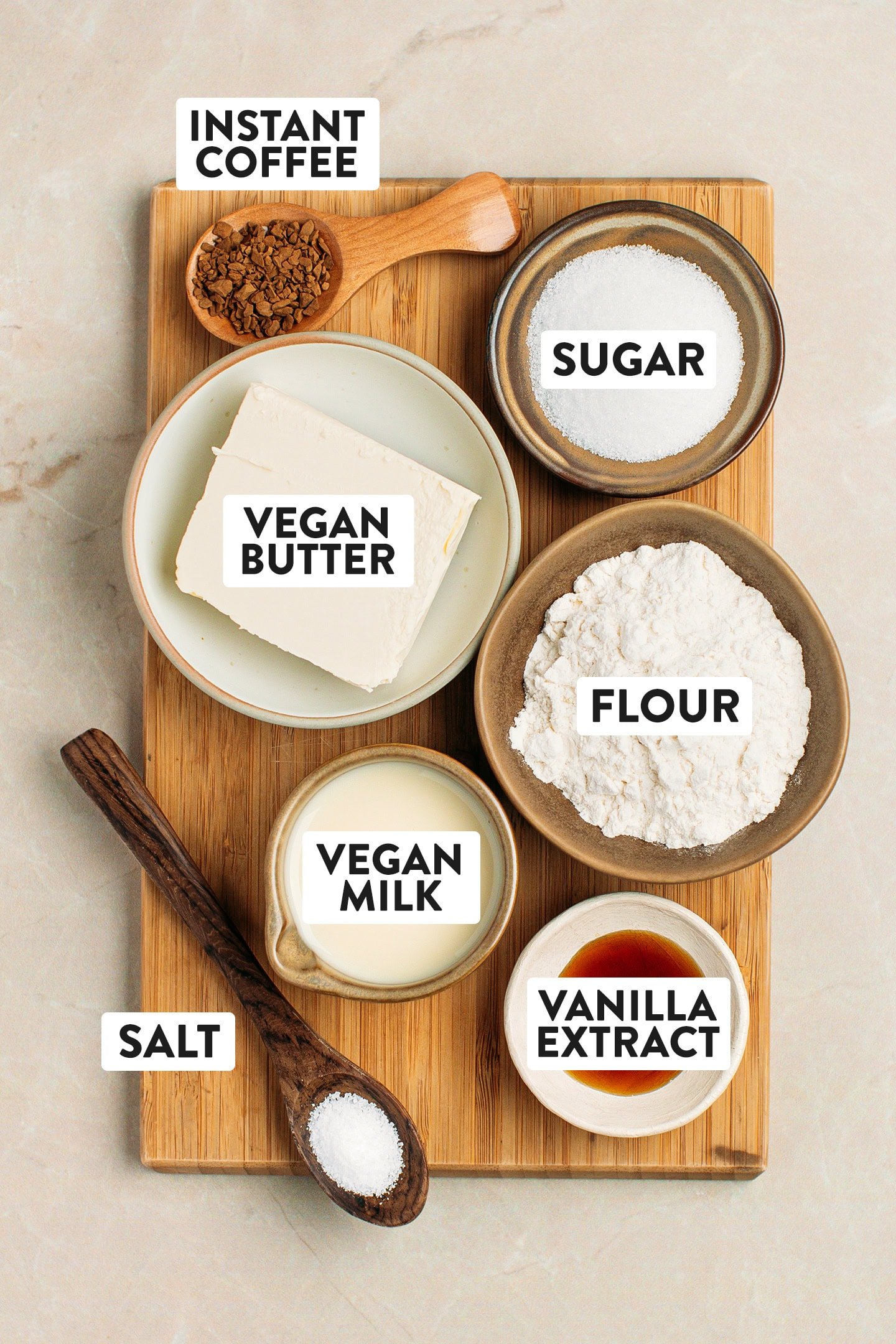Ingredients like flour, butter, vegan milk, vanilla extract, and instant coffee.