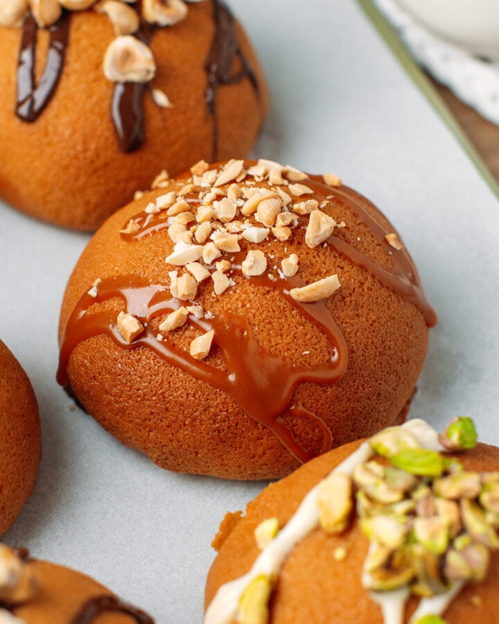 Close up of a Papparoti bun drizzled with caramel sauce and topped with crushed peanuts.