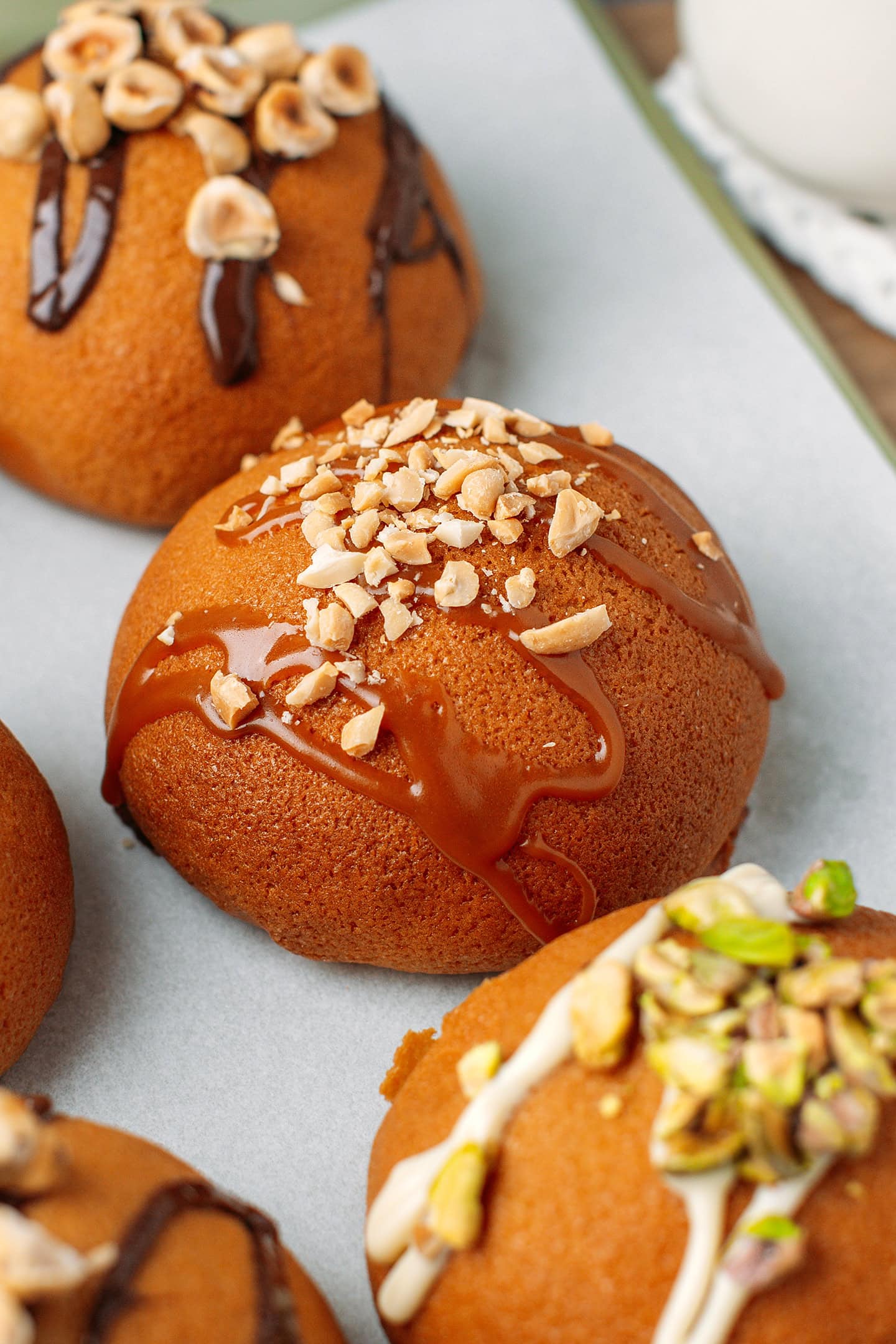 Close up of a Papparoti bun drizzled with caramel sauce and topped with crushed peanuts.