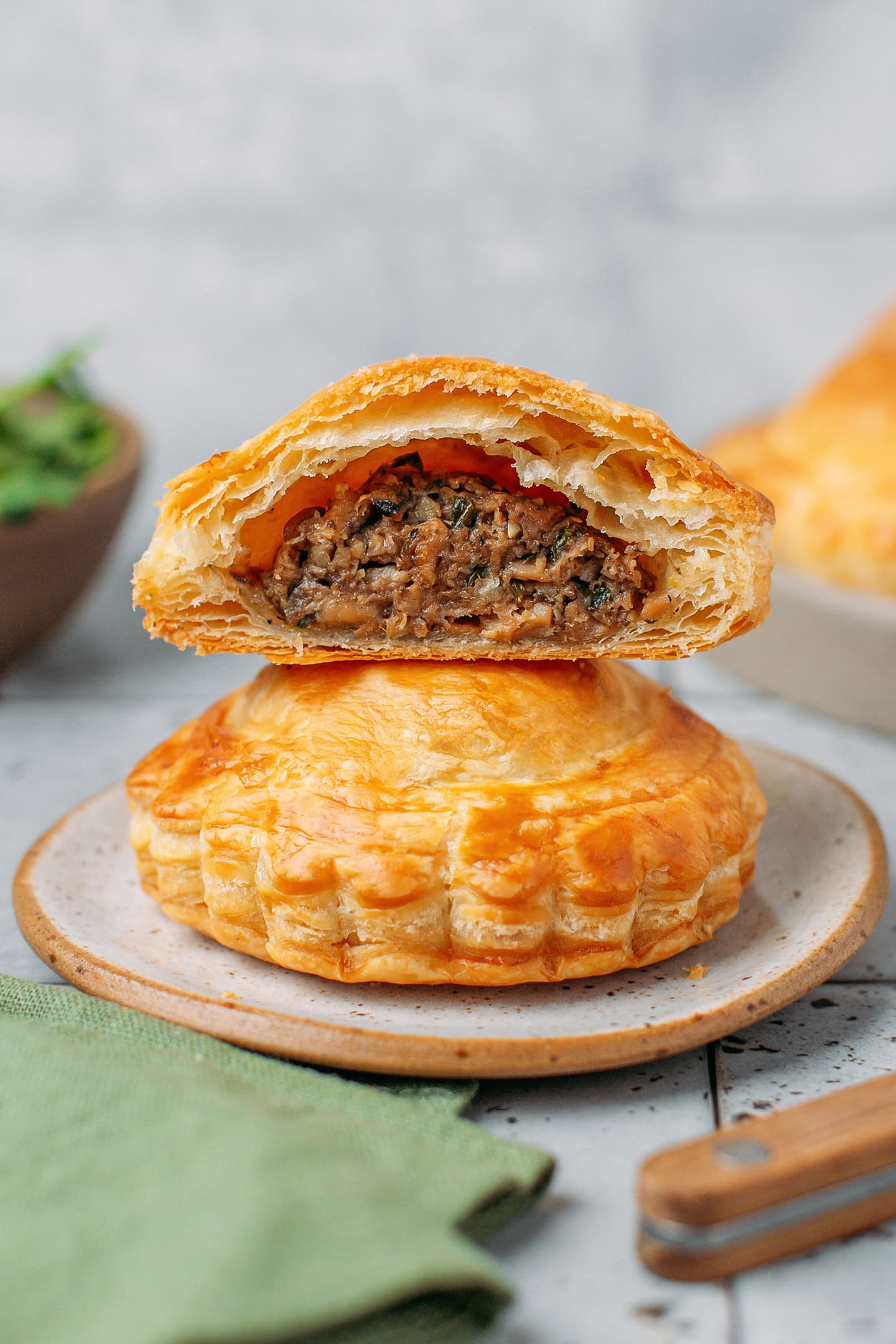 Two vegan p&acirc;t&eacute; chaud stacked on a small plate.