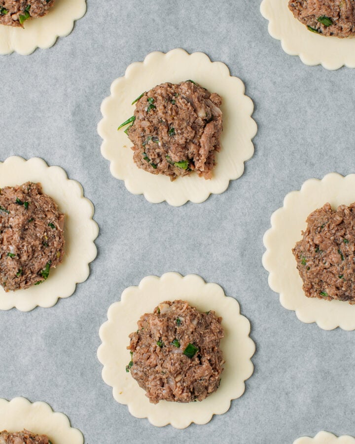 Rounds of puff pastry topped with a vegan meat filling.
