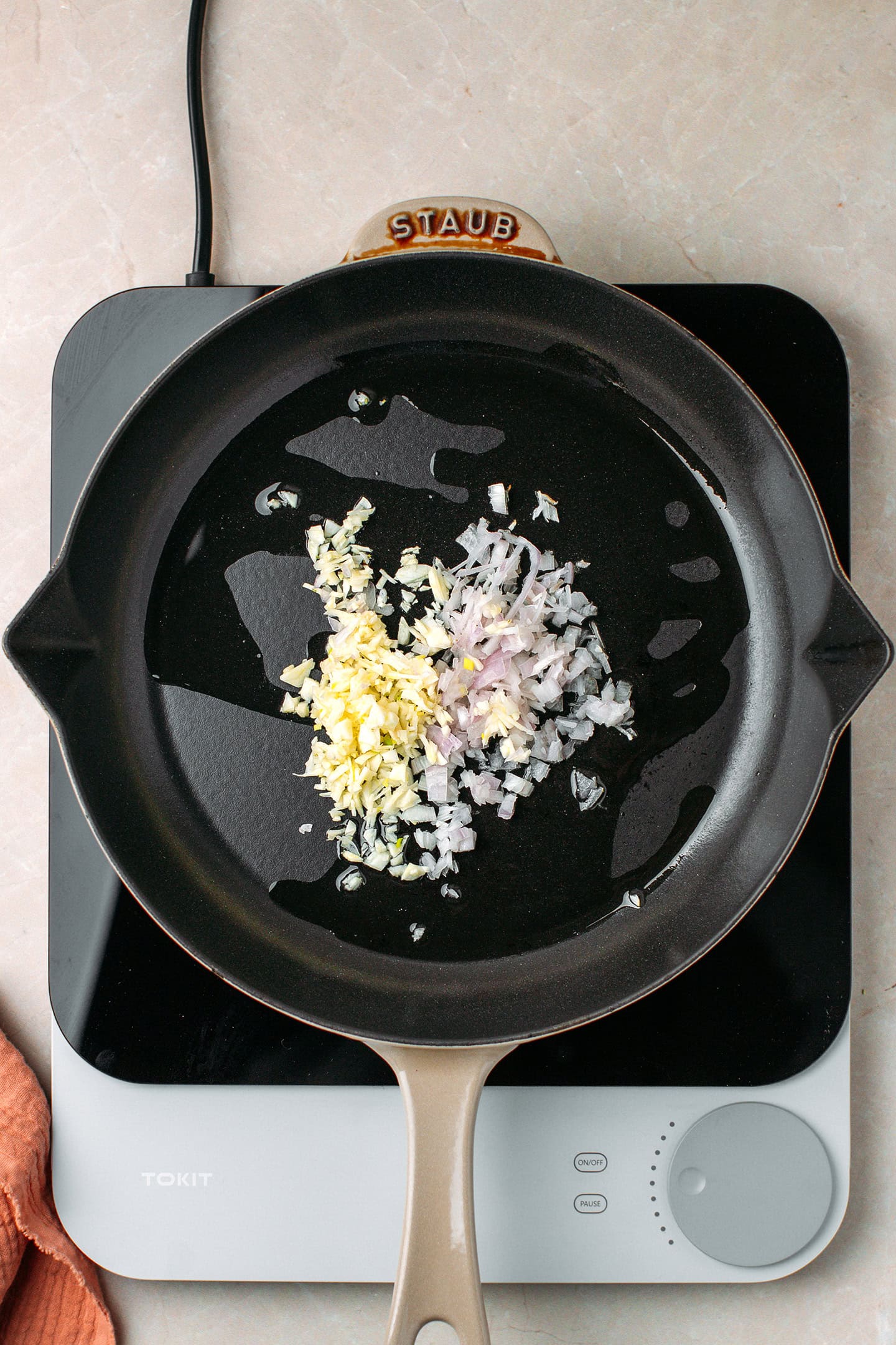 Chopped garlic and shallot in a skillet.