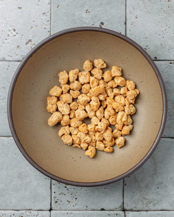 TVP soy chunks in a brown bowl.