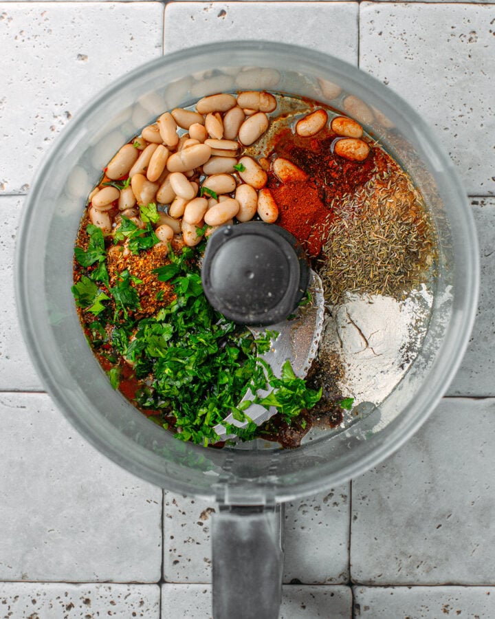 Cooked white beans, parsley, thyme, and onion powder in a food processor.