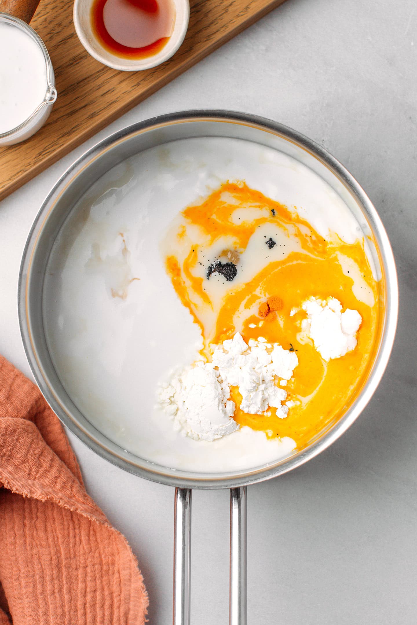 Coconut milk, melted butter, cornstarch, potato starch, and vanilla extract in a saucepan.