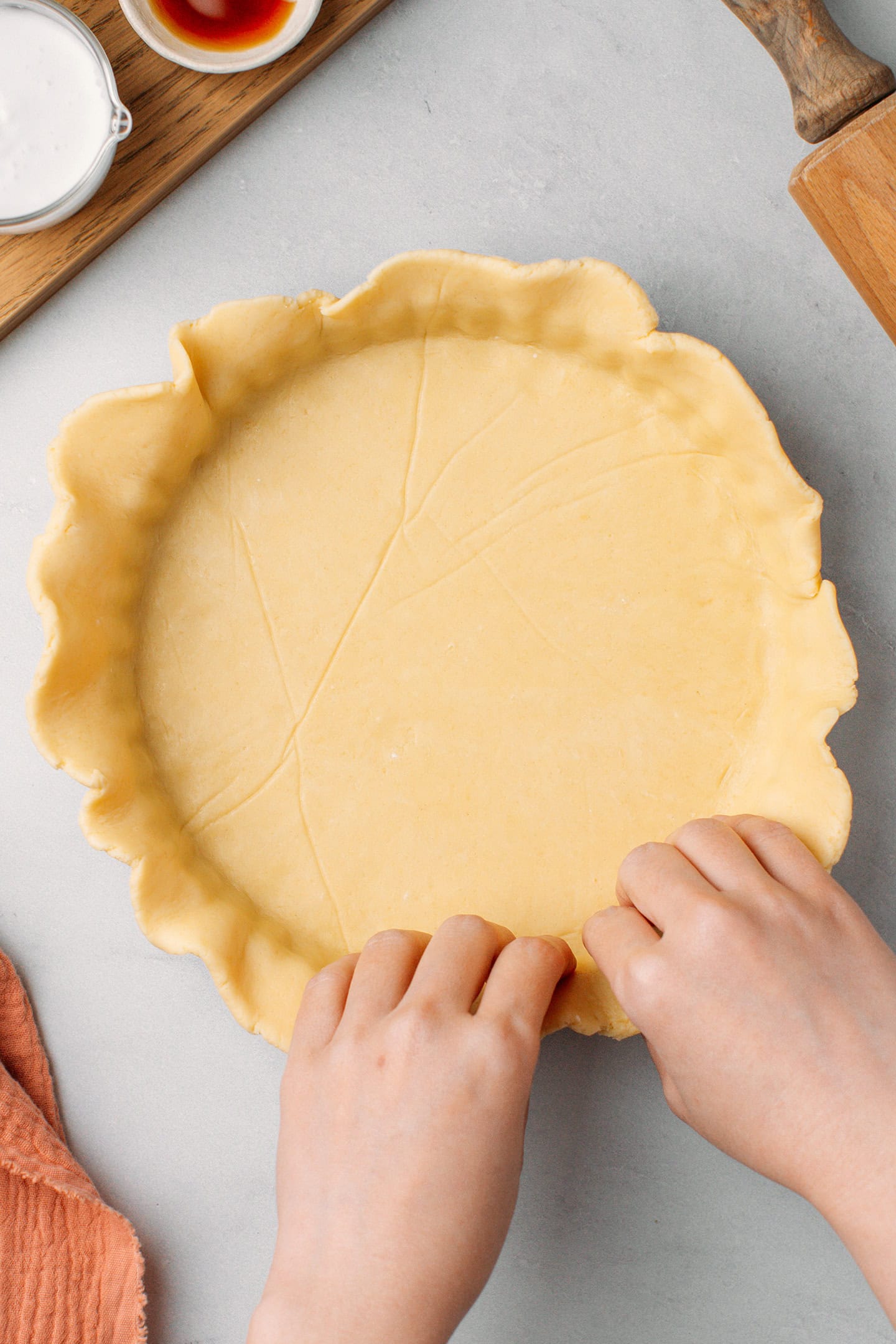Pressing a dough into a tart pan.