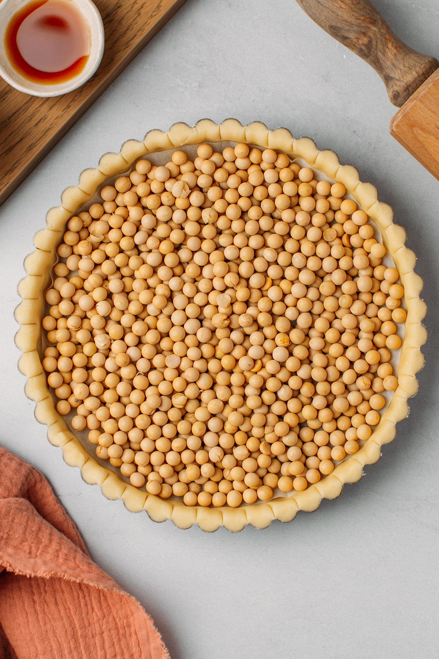 Unbaked pie crust filled with soybeans.