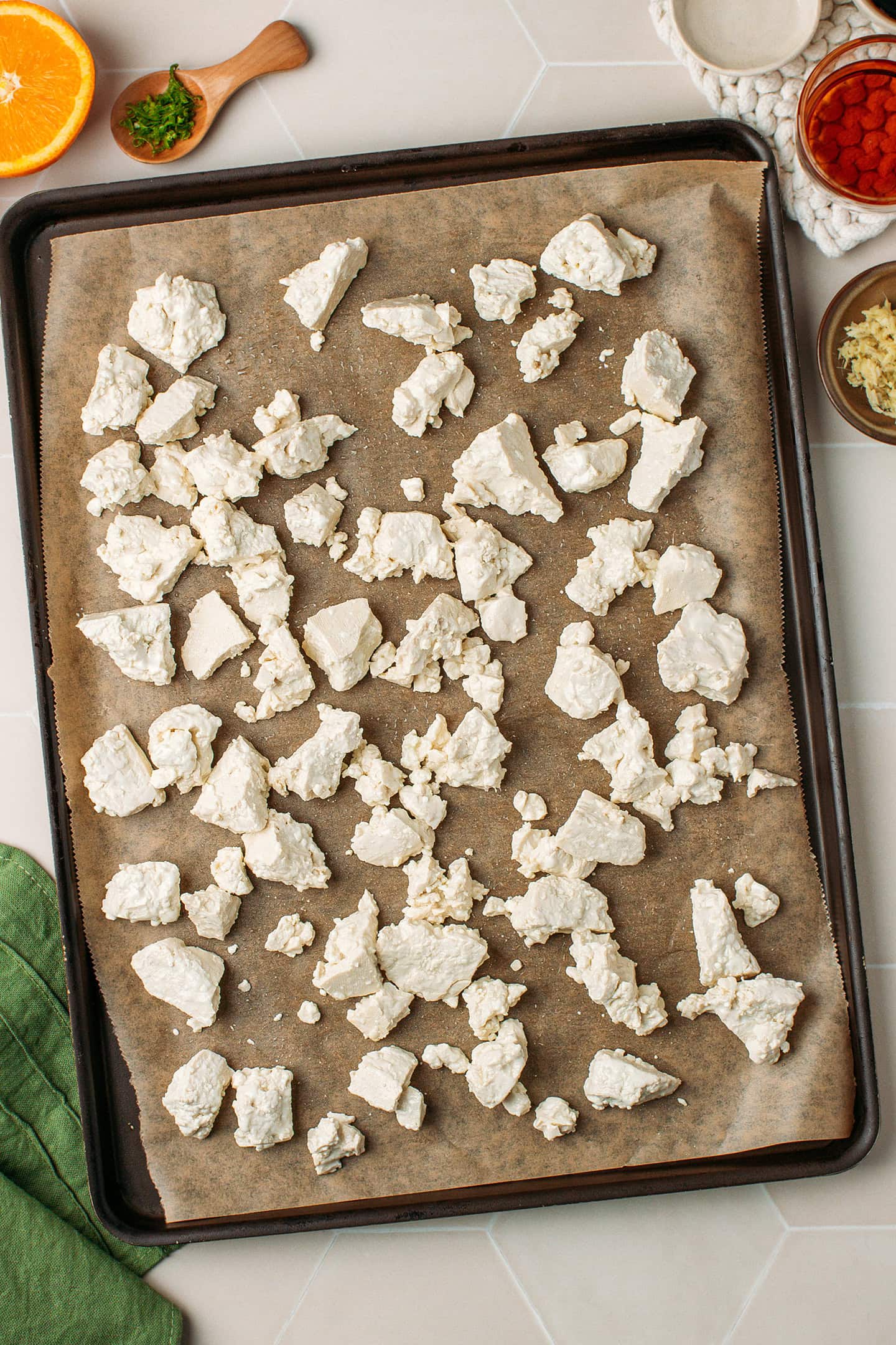 Crumbled tofu pieces on a baking sheet.