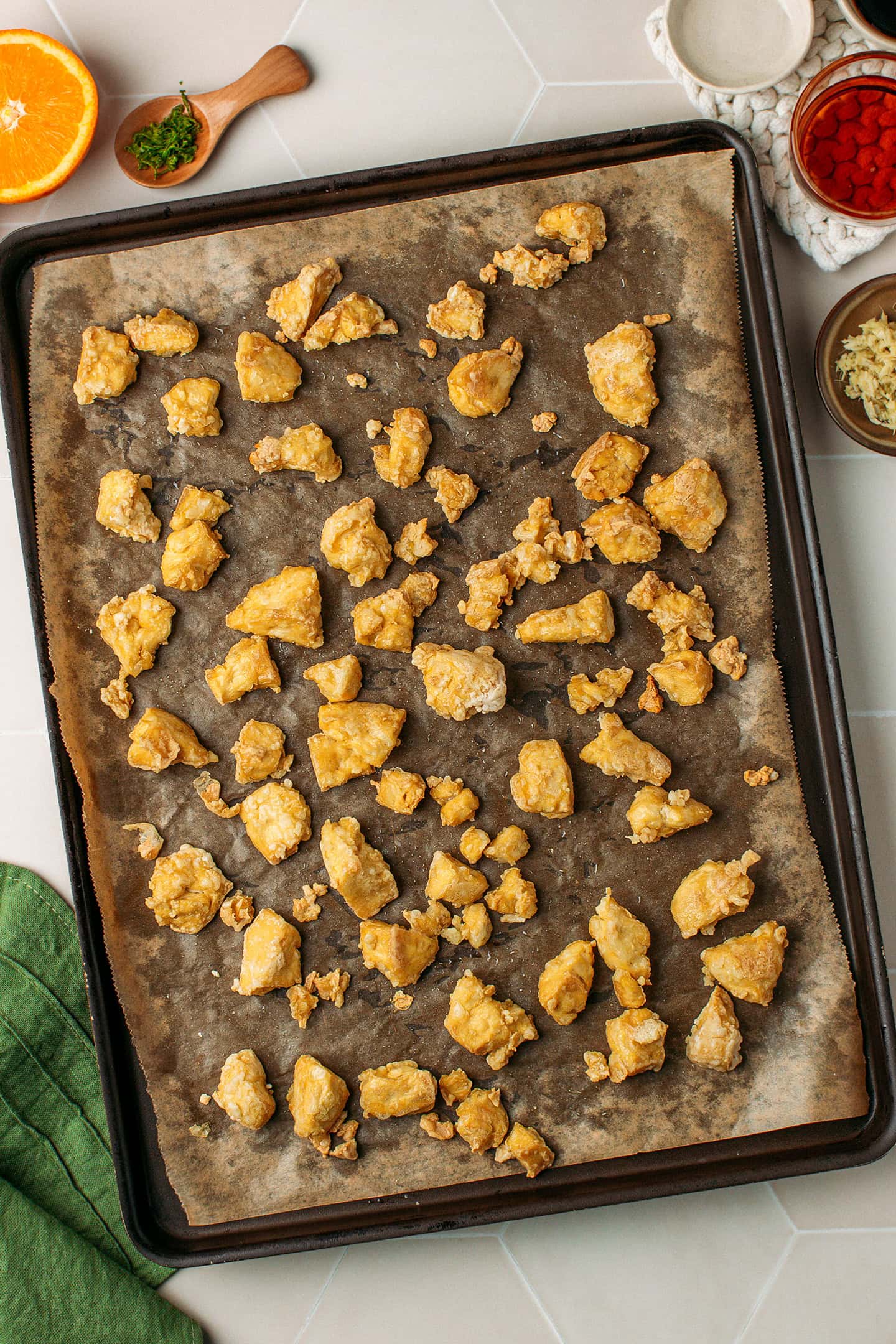 Golden brown tofu pieces on a baking sheet.