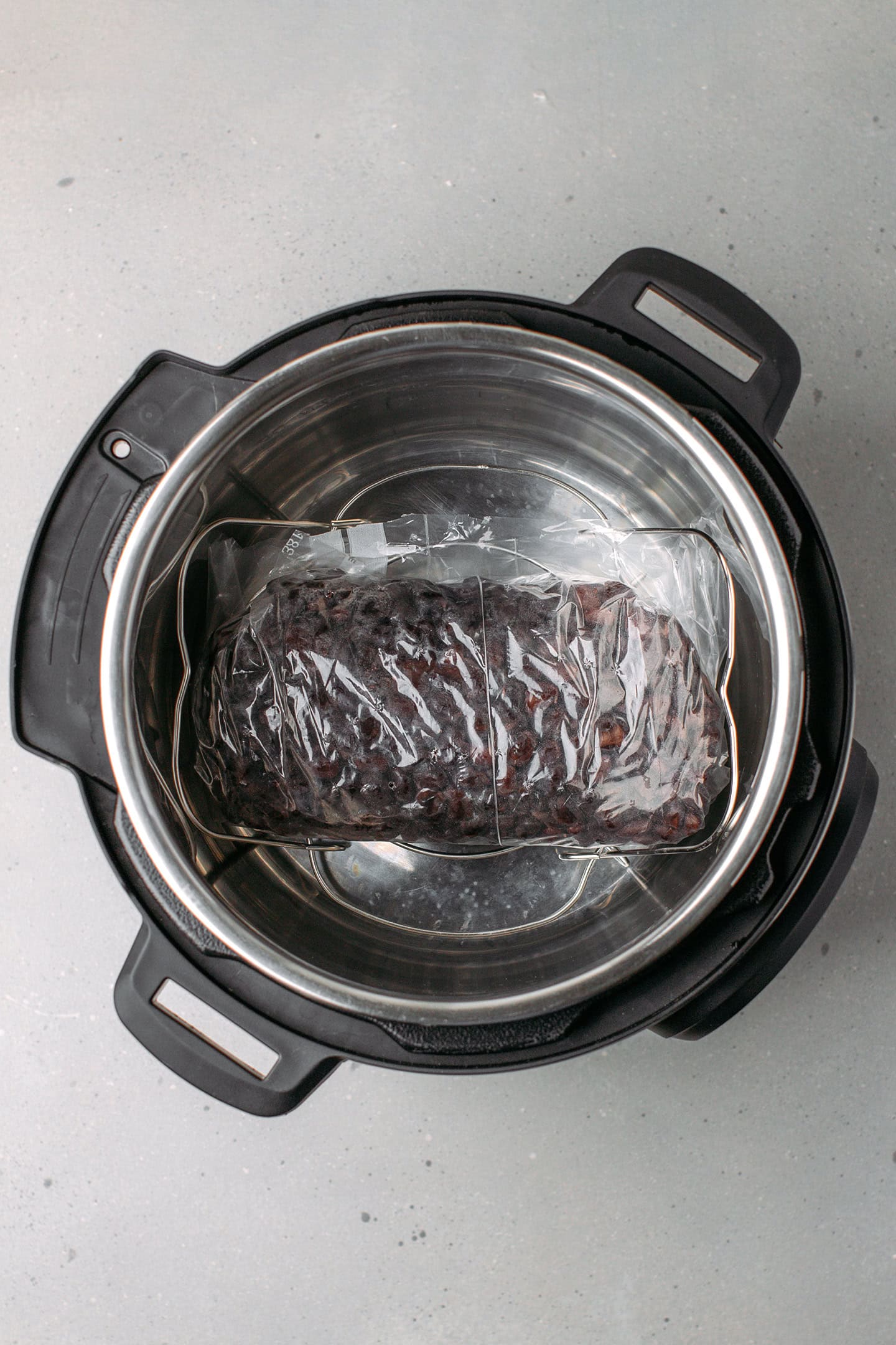 Loaf of cooked black beans in an Instant Pot.