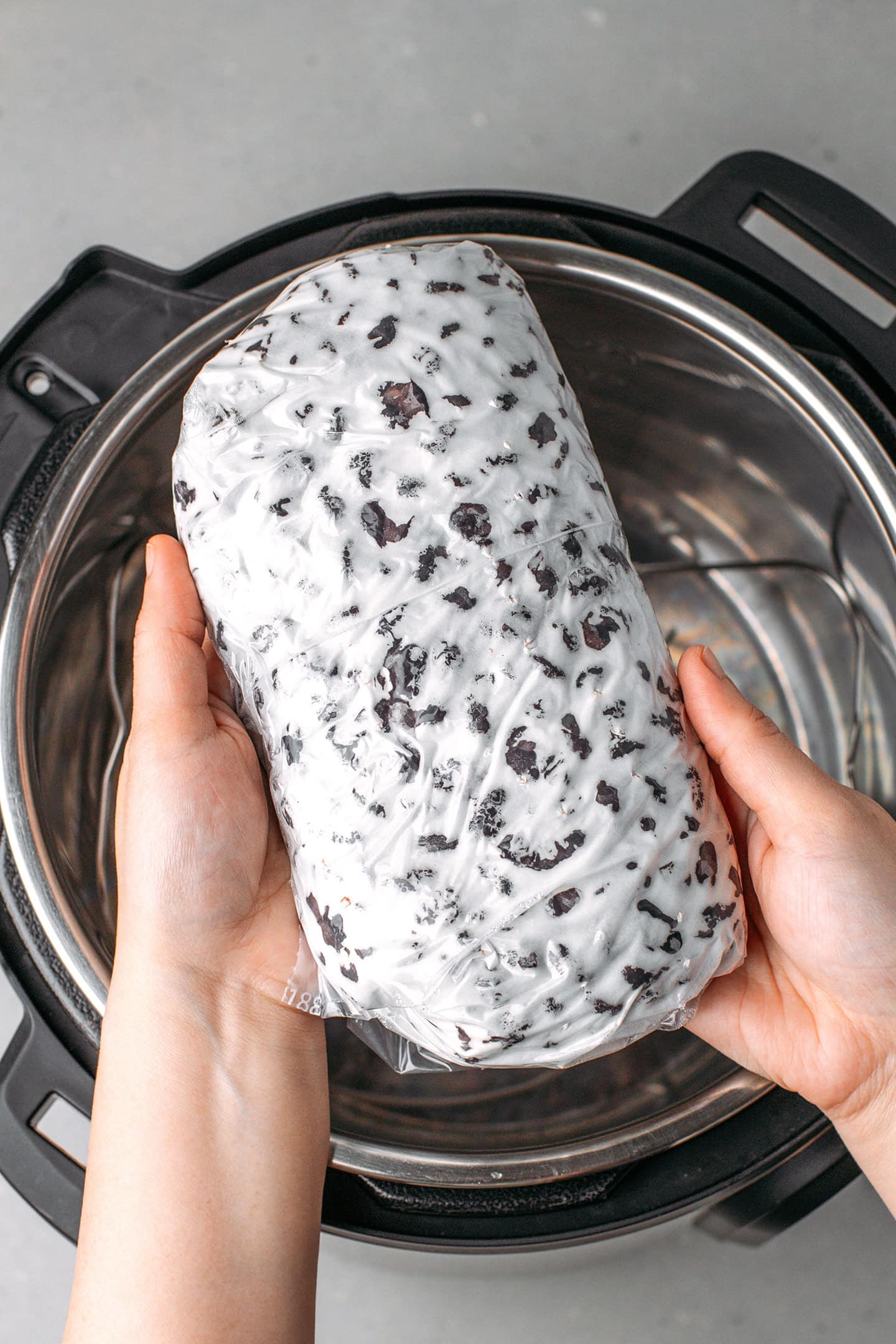 Holding a loaf of black bean tempeh.