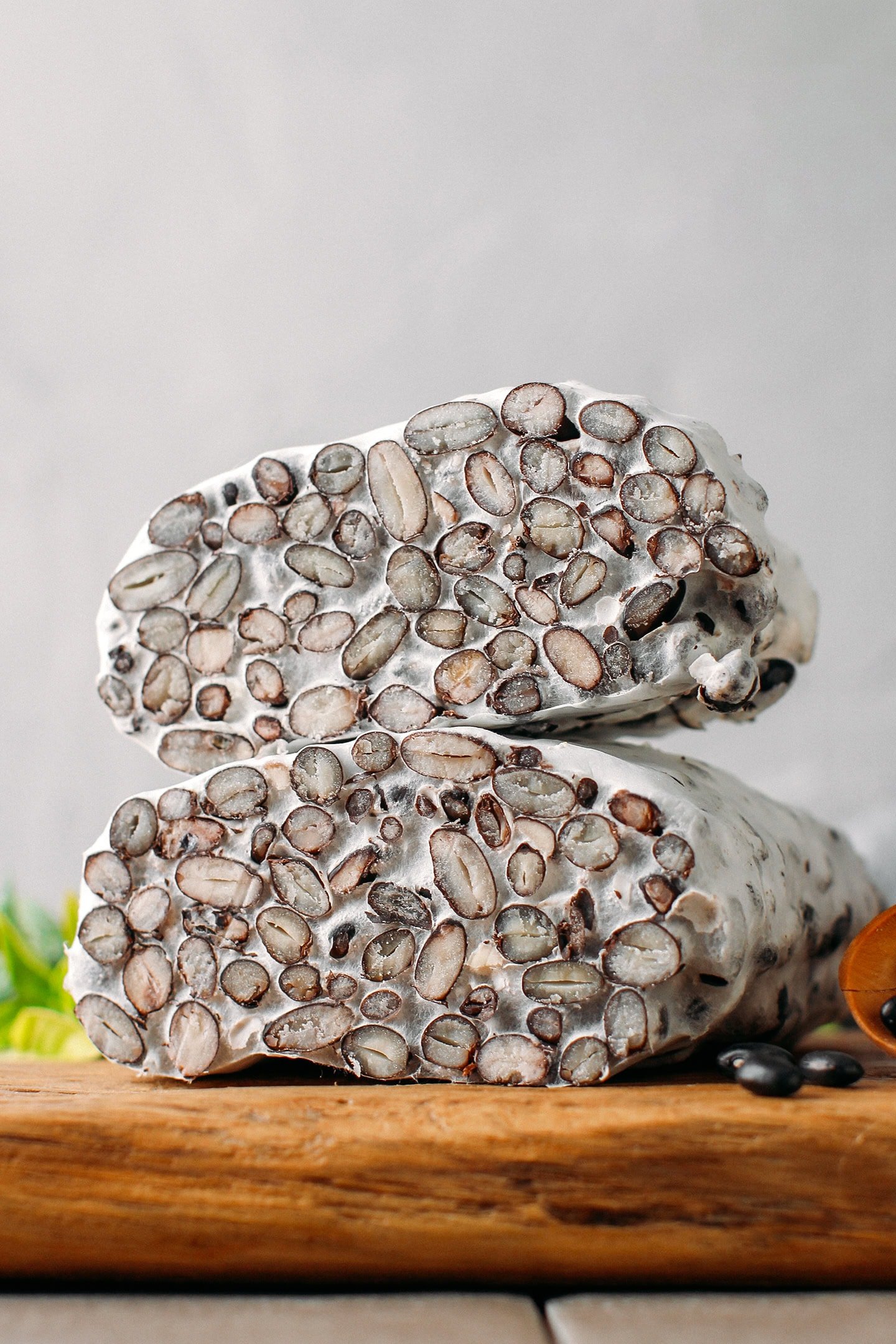 Two loaves of black bean tempeh stacked.