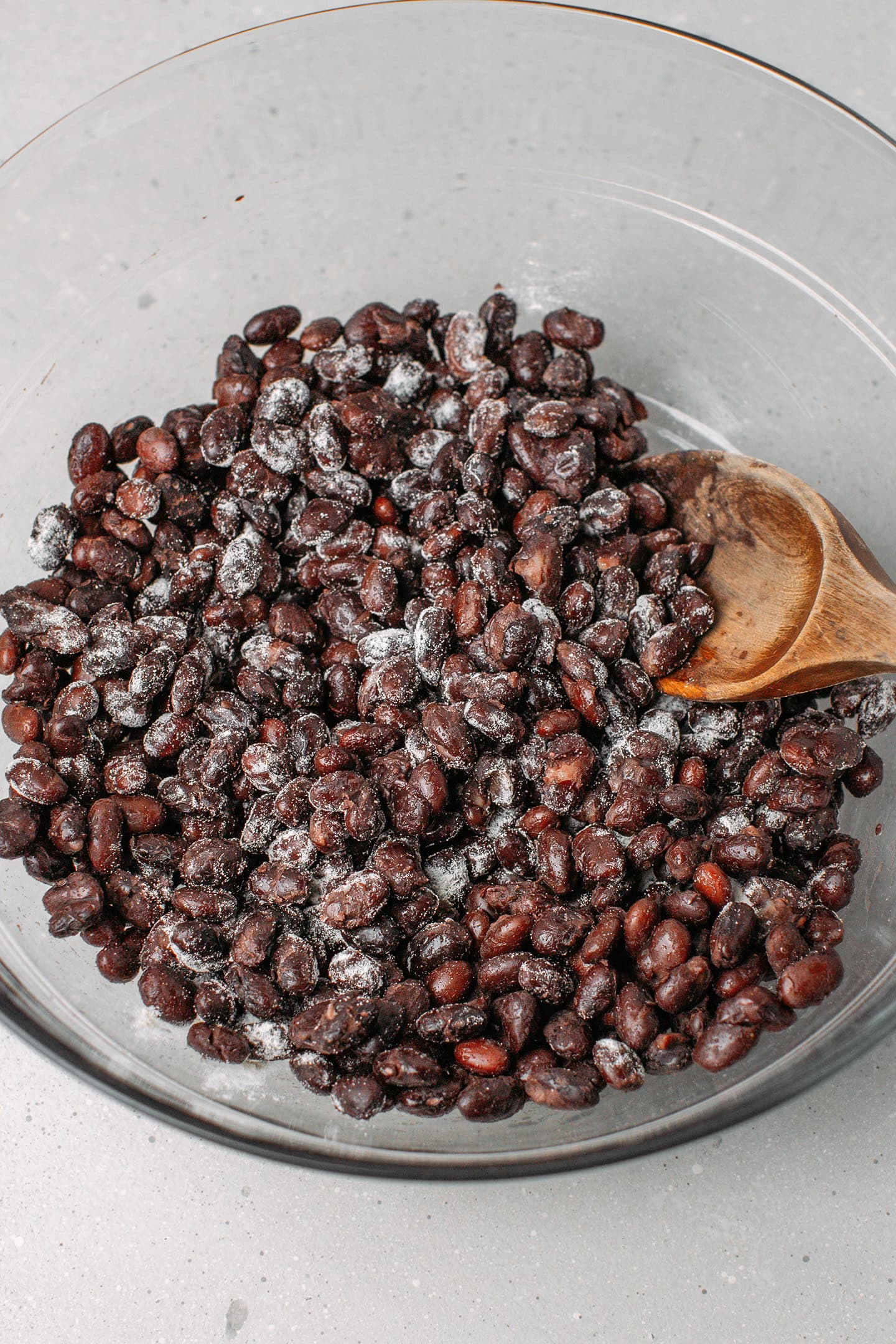 Close-up of cooked black beans tossed with tempeh starter.