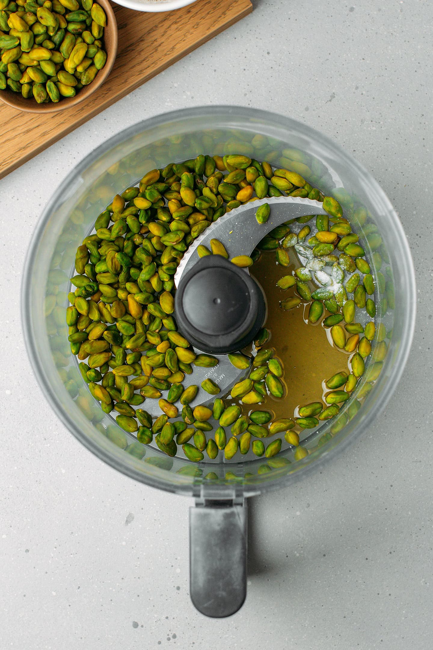 Pistachio kernels, maple syrup, and salt in a food processor.