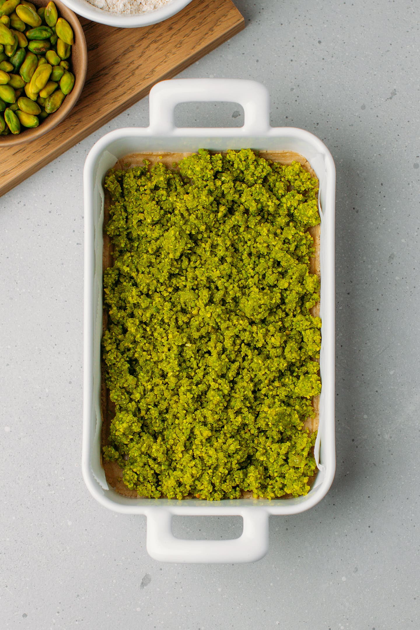Pistachio meal into a baking dish.