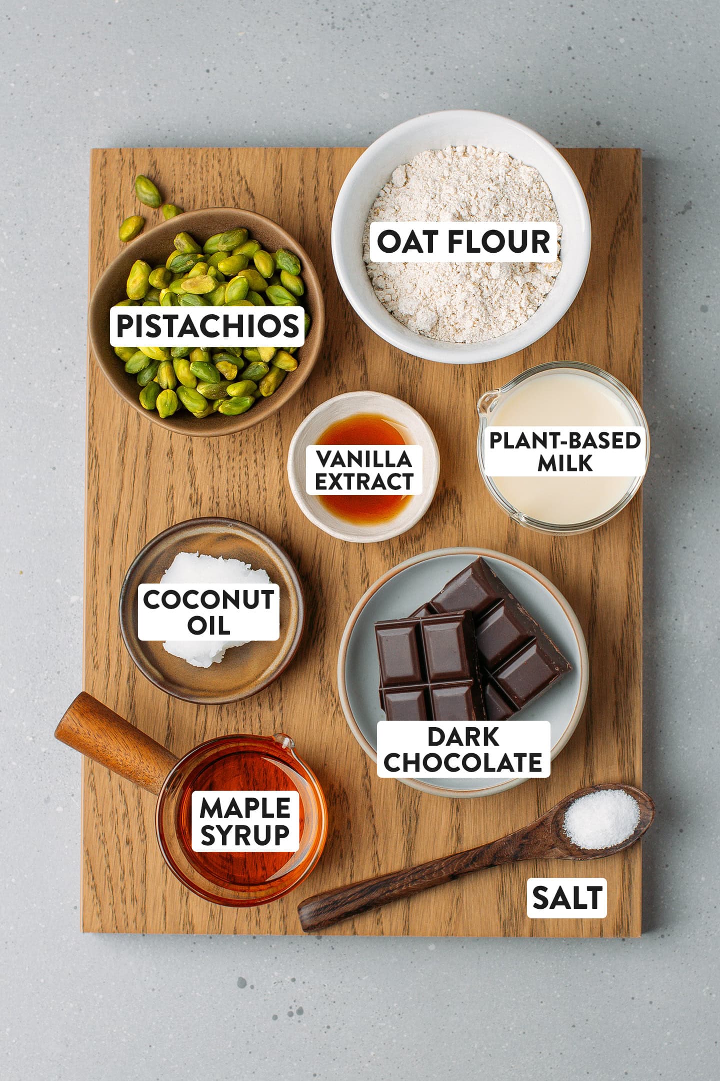 Ingredients like pistachios, oat flour, dark chocolate, and maple syrup.