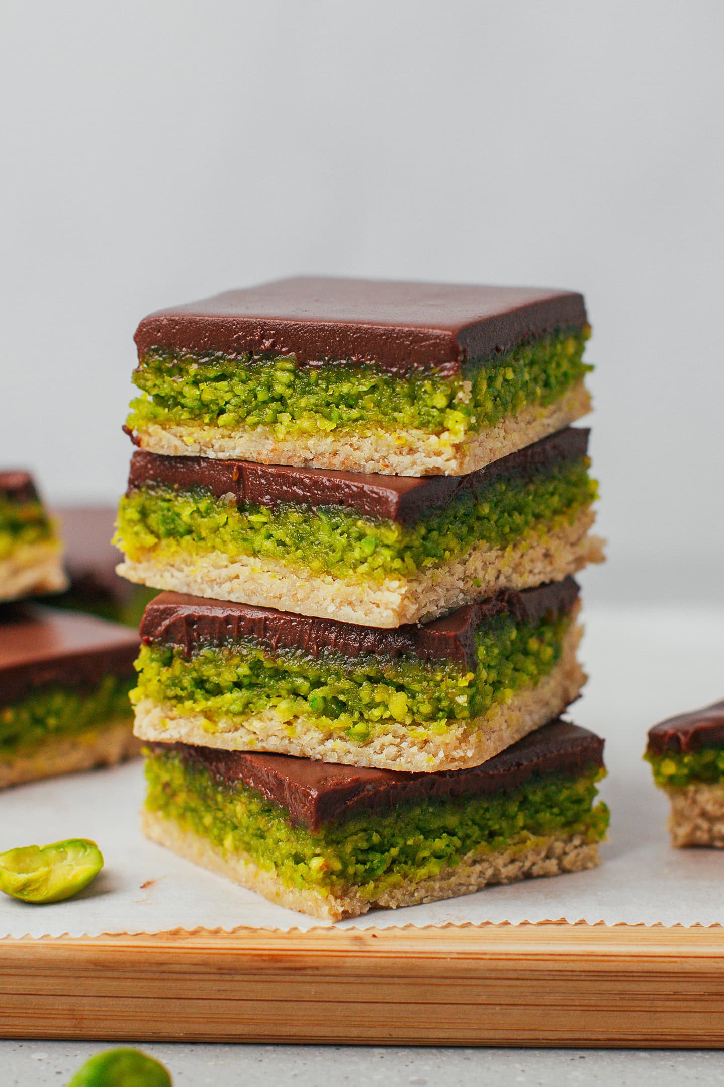 Four chocolate pistachio bars stacked.