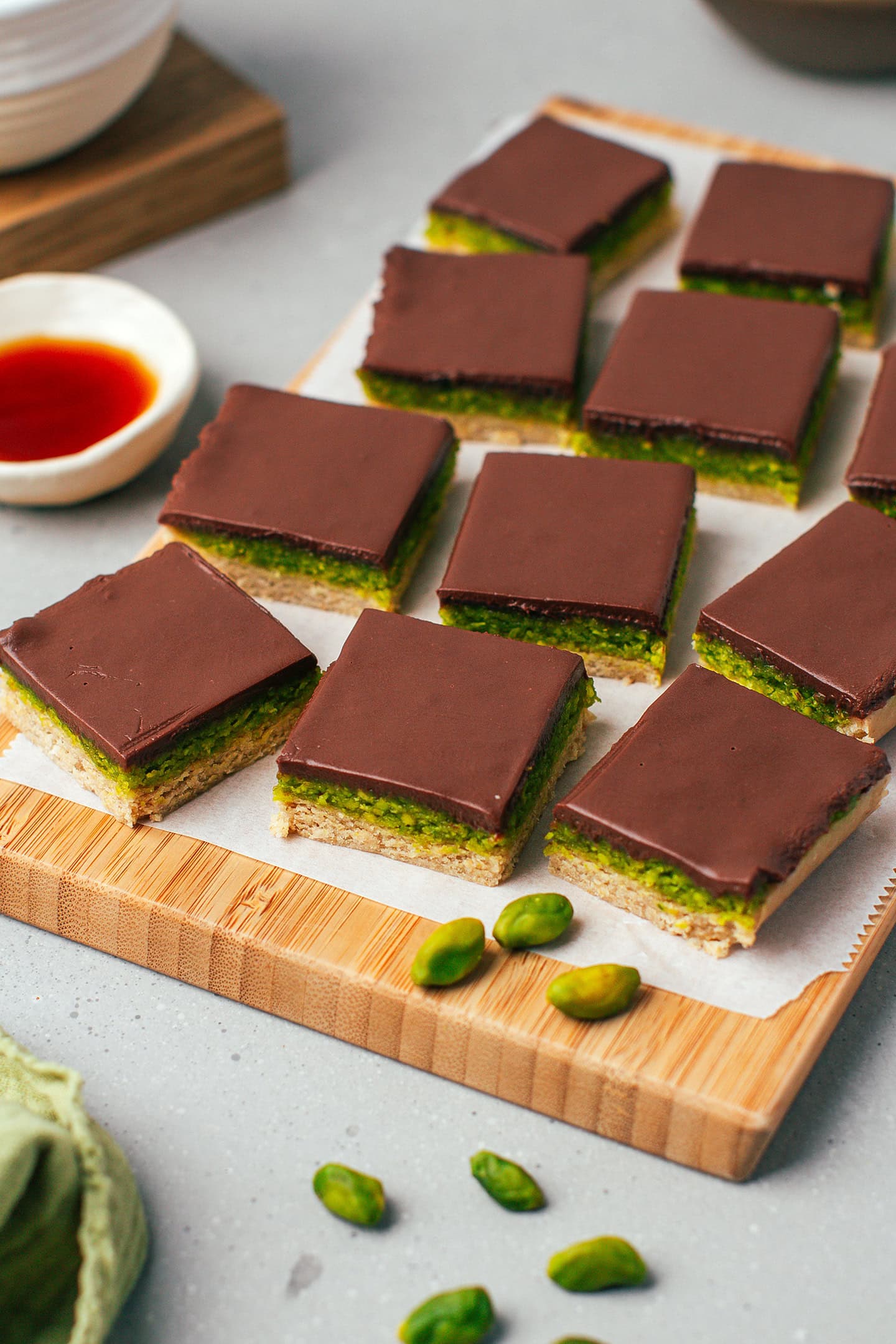 Close-up of pistachio squares on a cutting board.