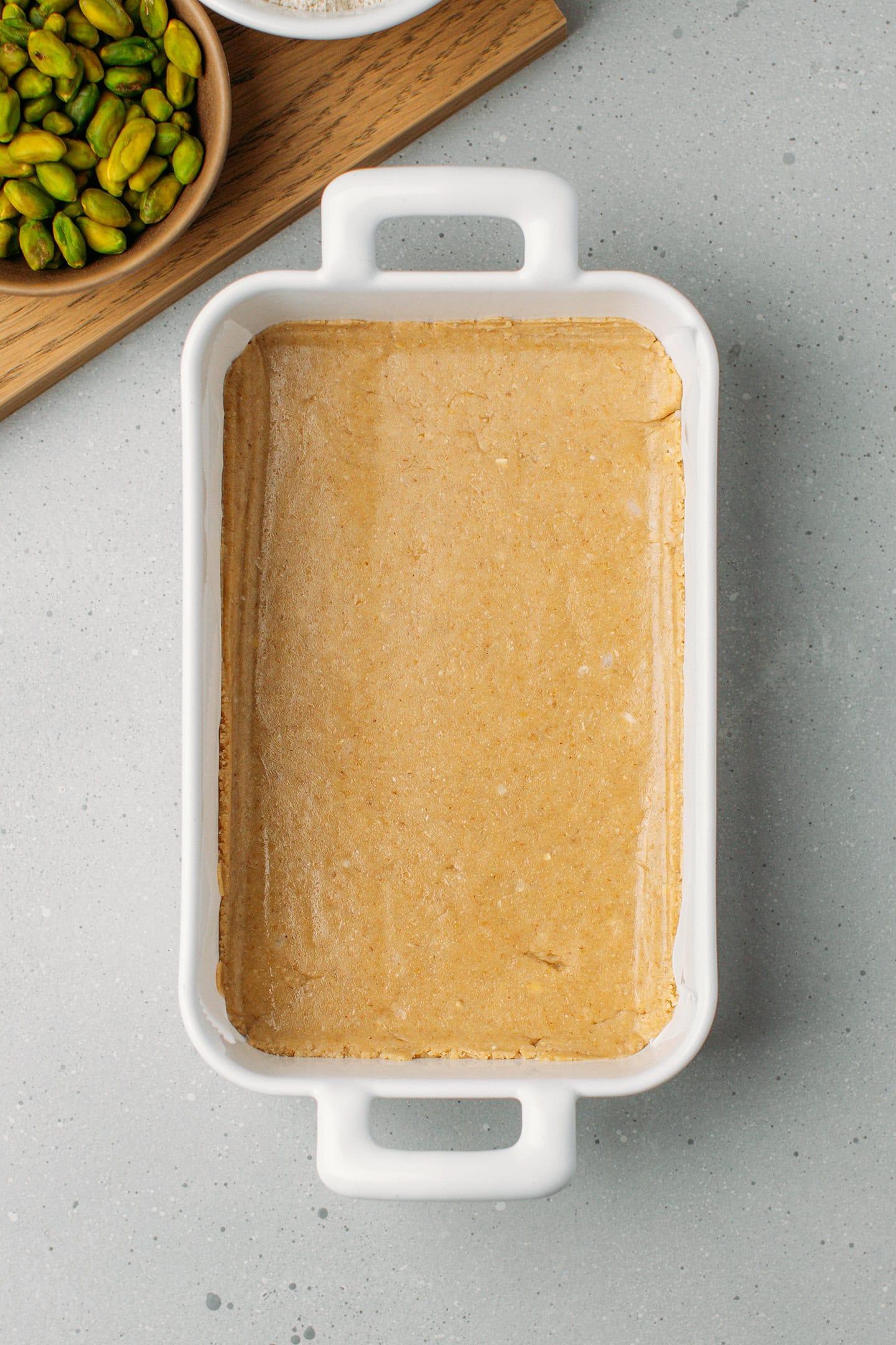 Flattened no-bake shortbread in a baking sheet.
