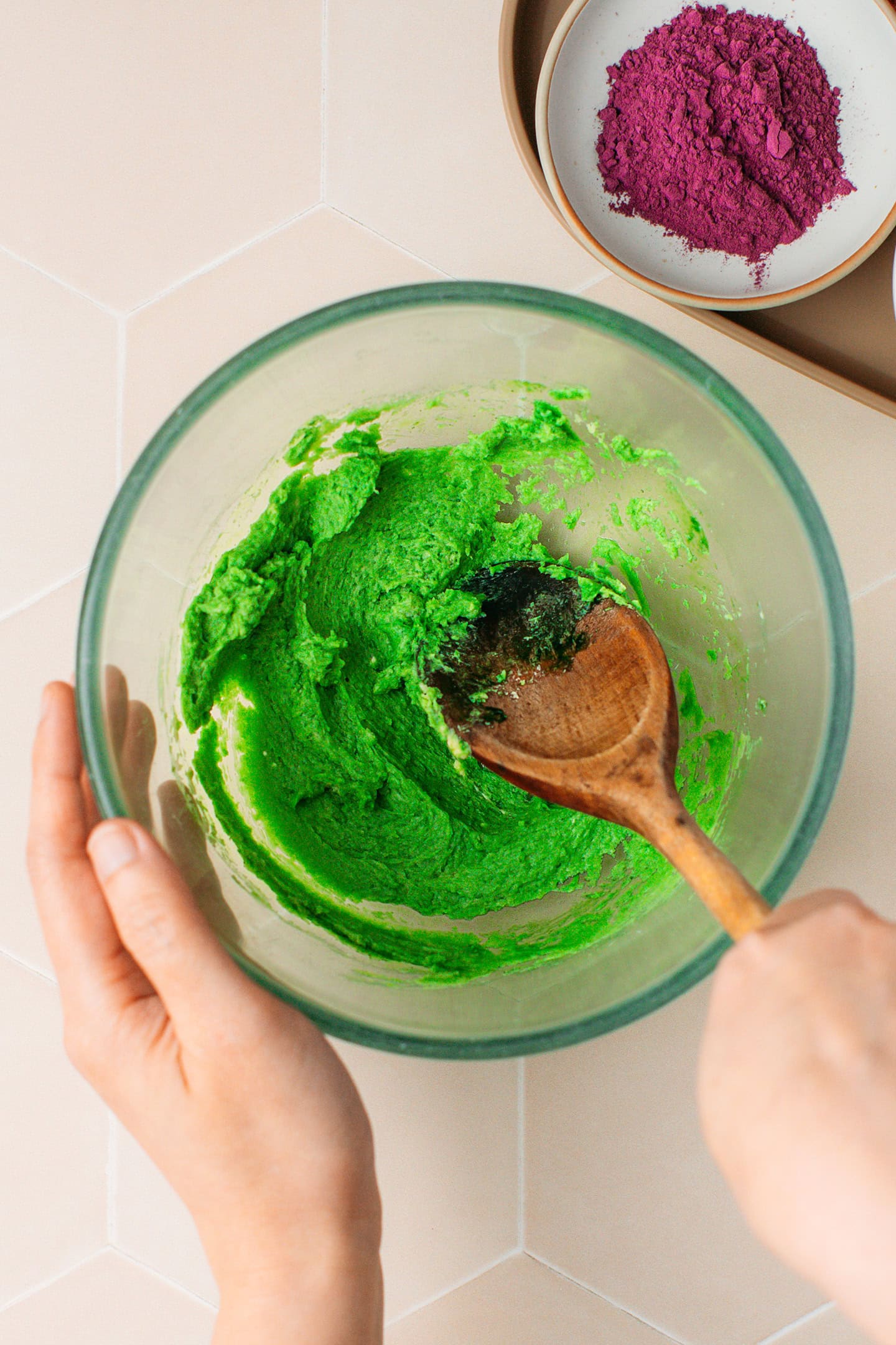 Mixing creamed butter with pandan extract.
