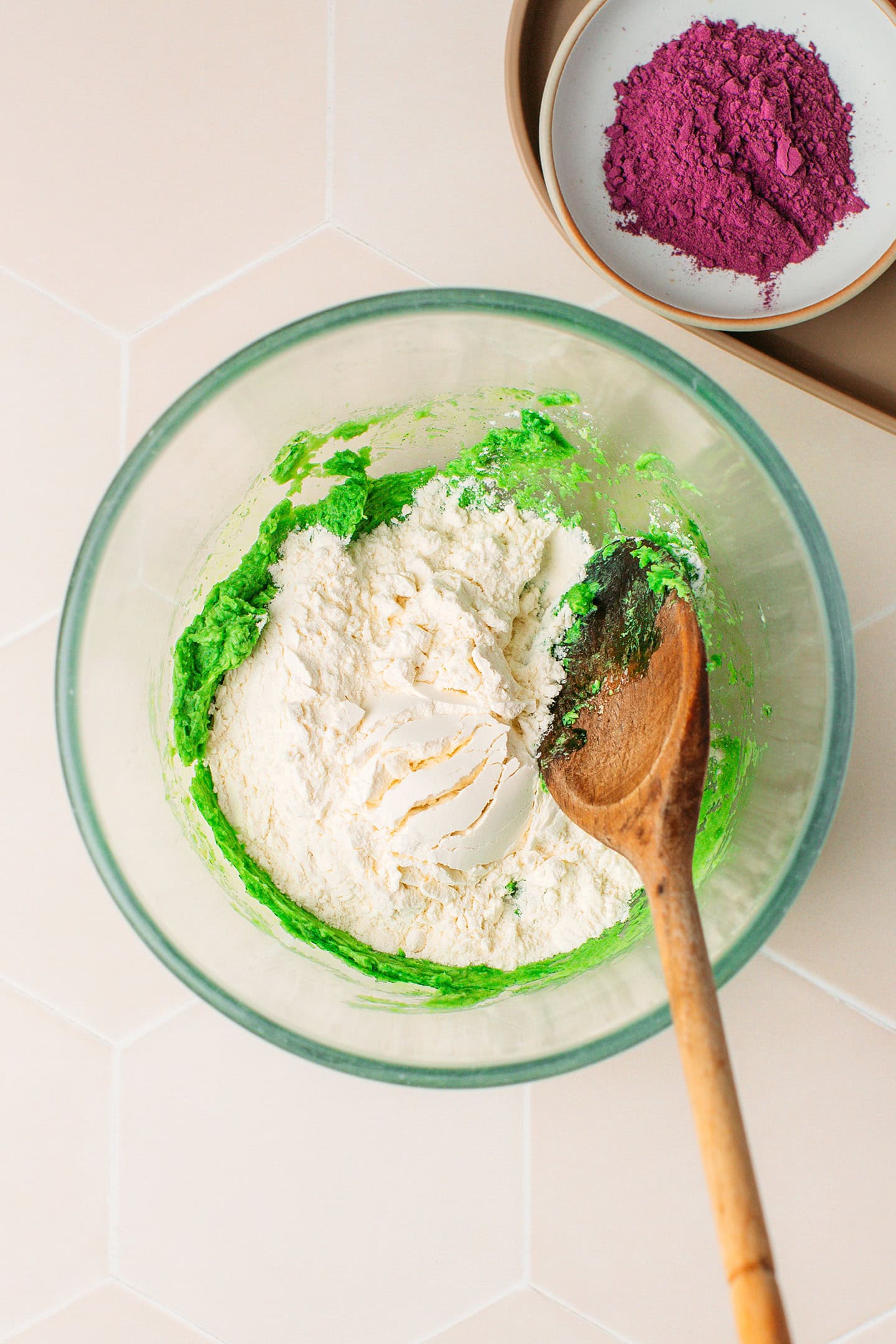 Creamed pandan butter and flour in a bowl.