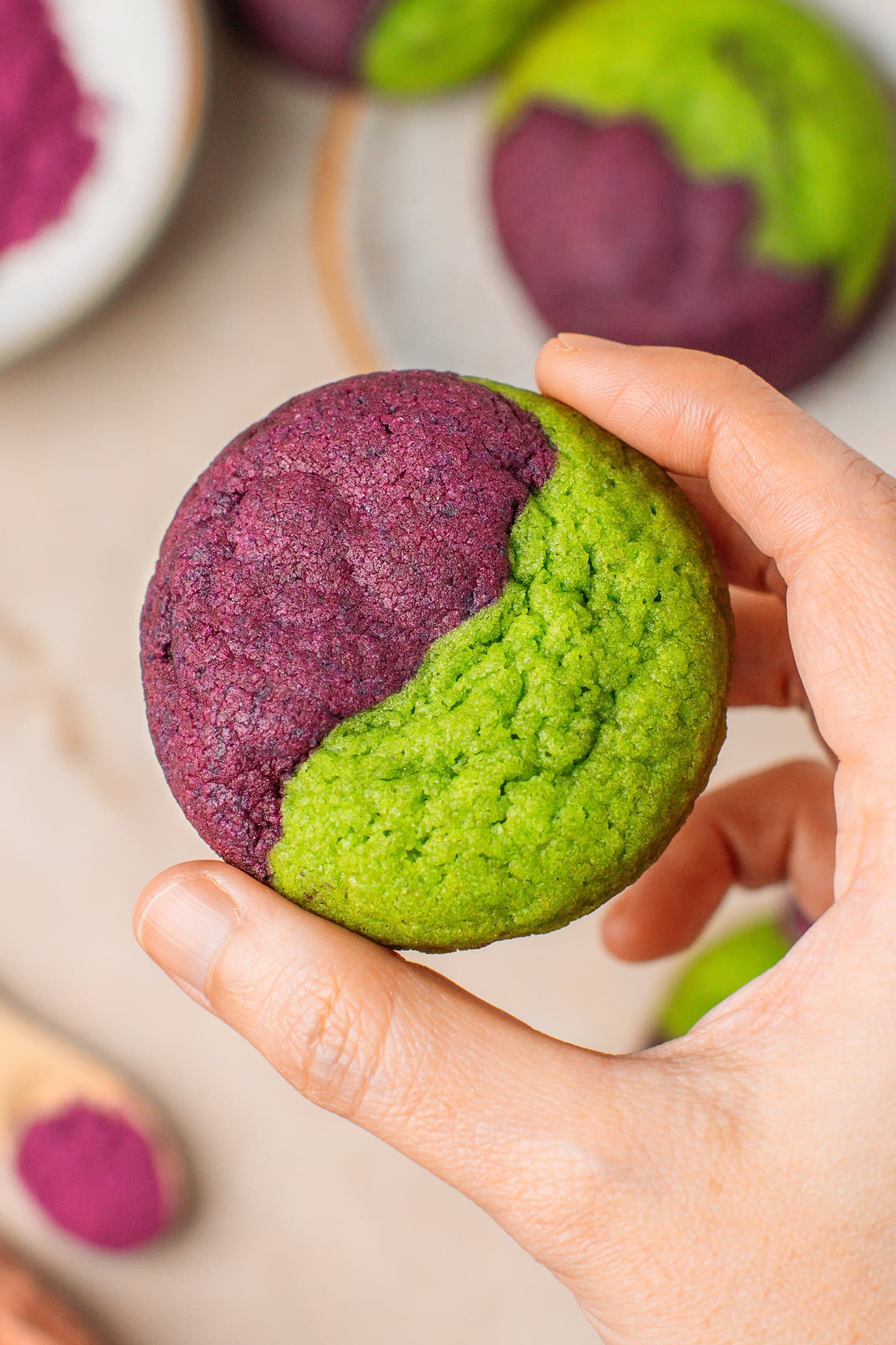 Holding an ube pandan cookie.
