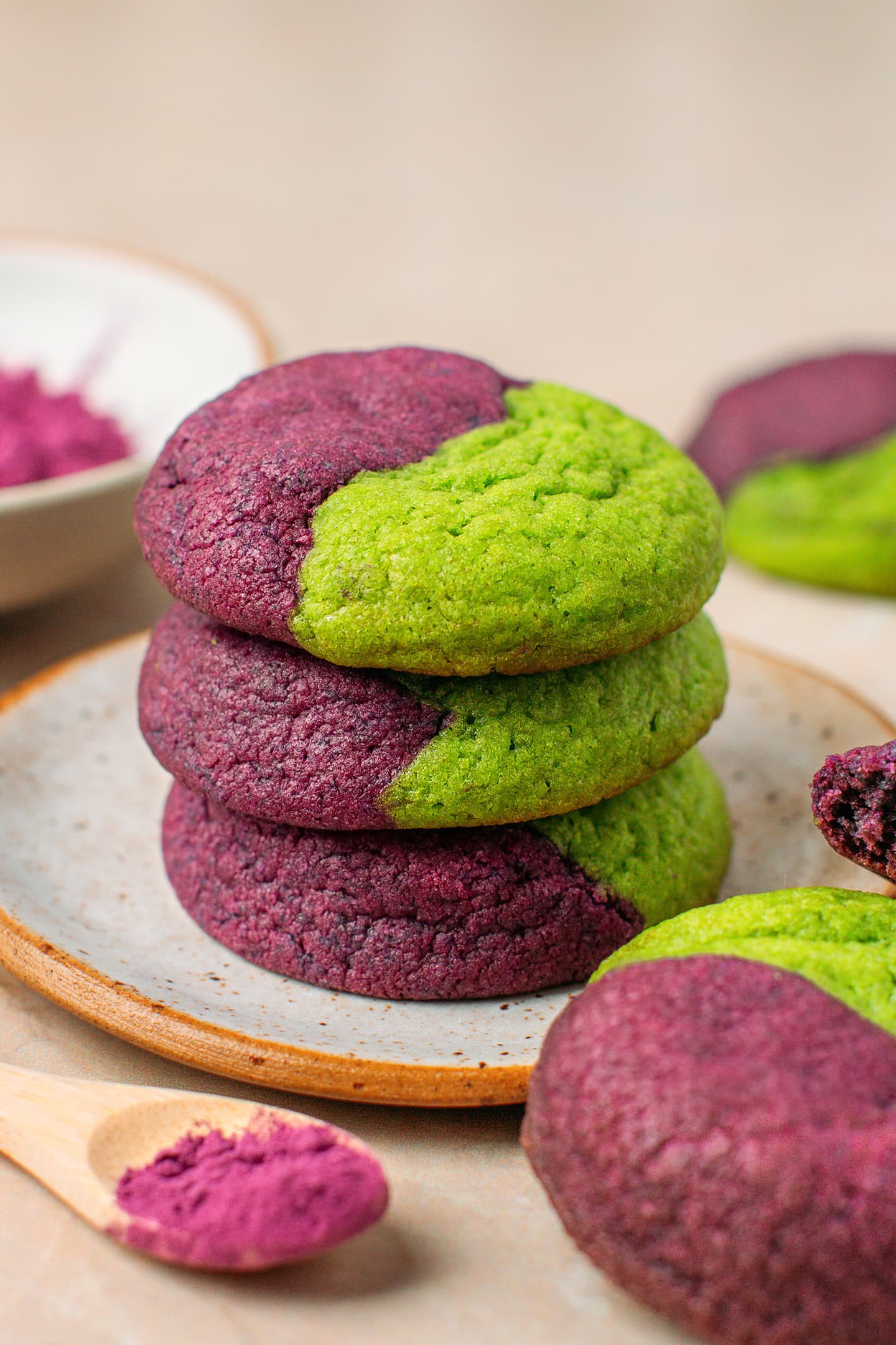 Three ube pandan cookies stacked on a small plate.
