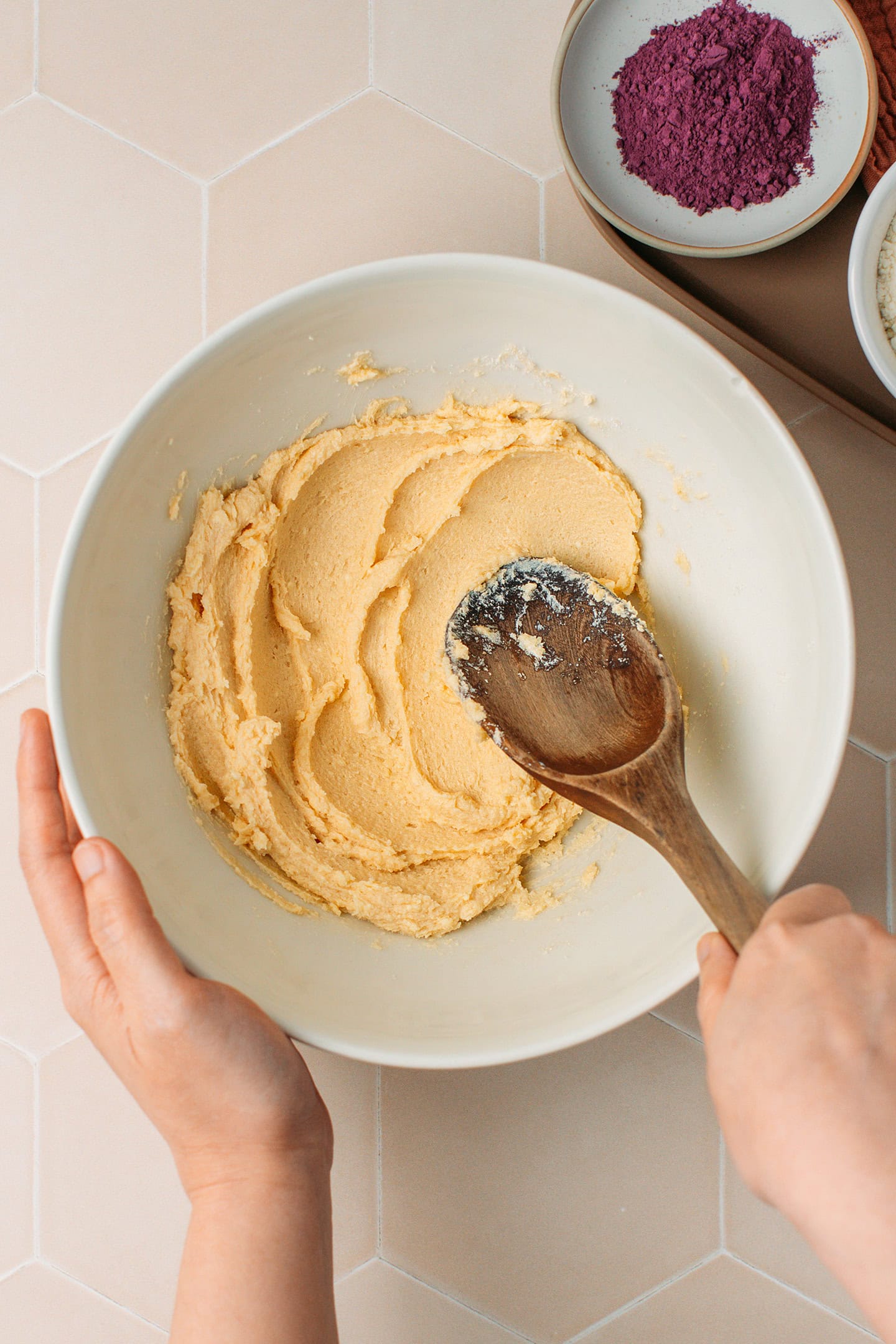 Creaming butter with sugar in a mixing bowl.
