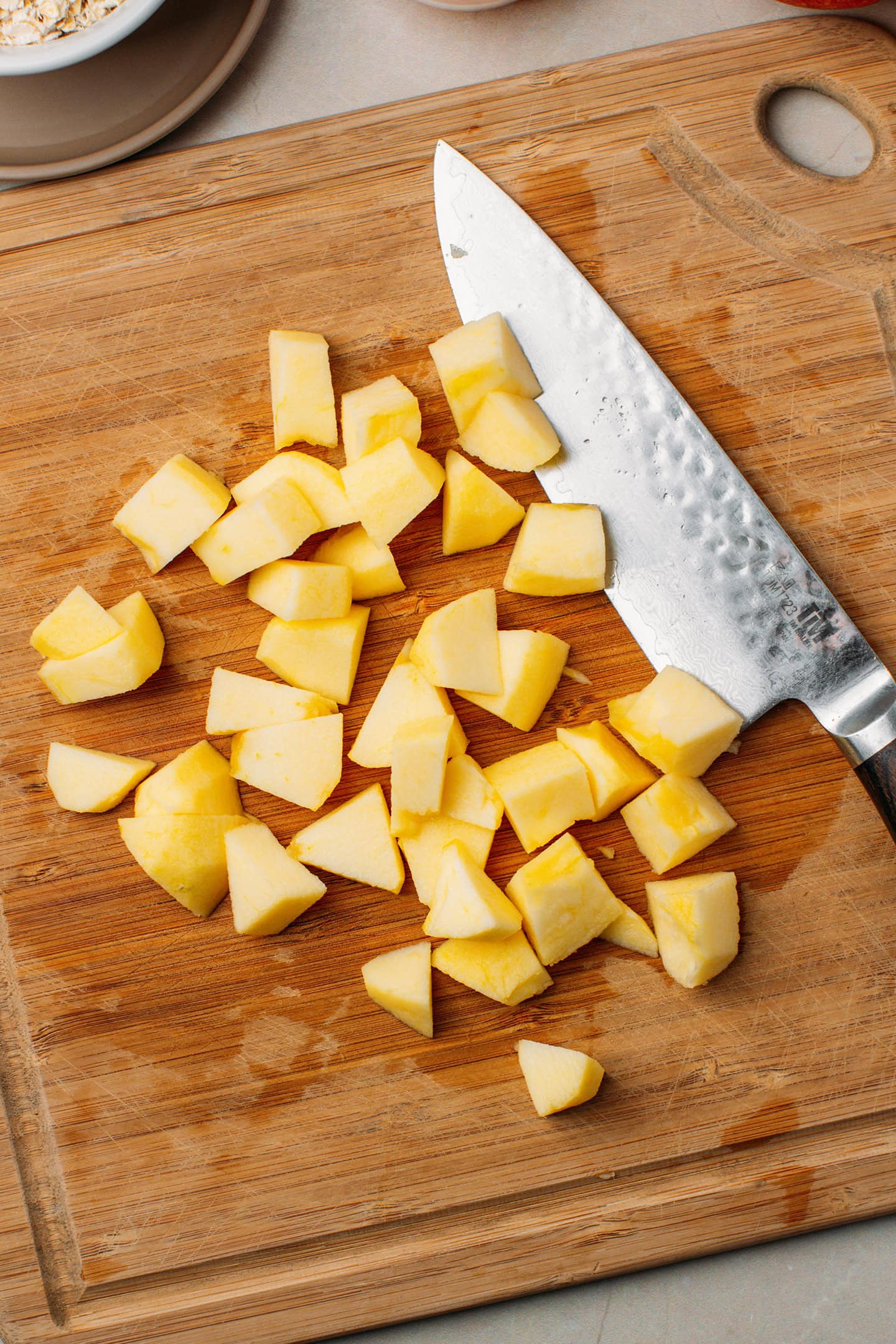 Diced apples on a cutting board.