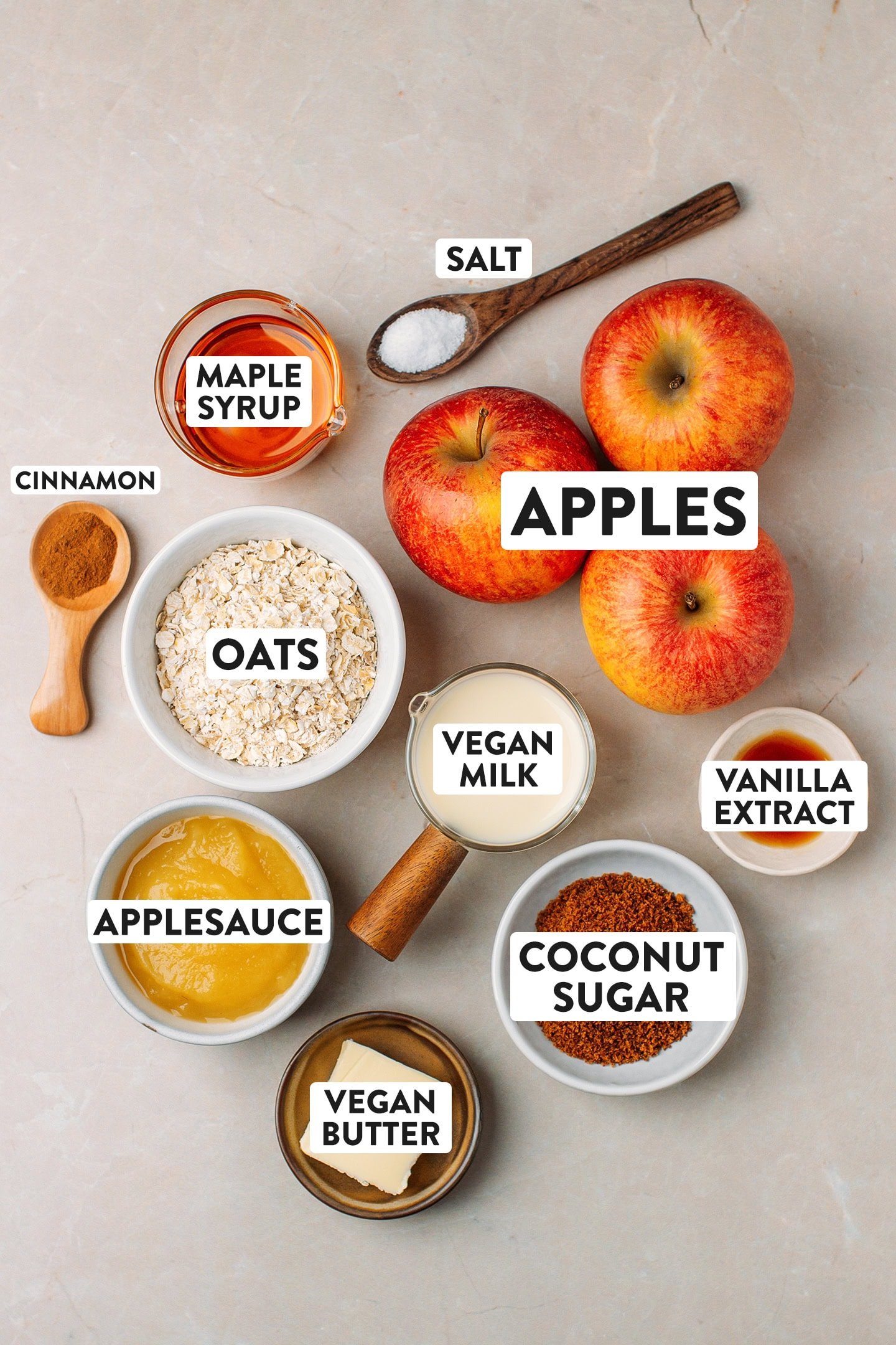 Ingredients like apples, oats, vegan milk, coconut sugar, and applesauce.
