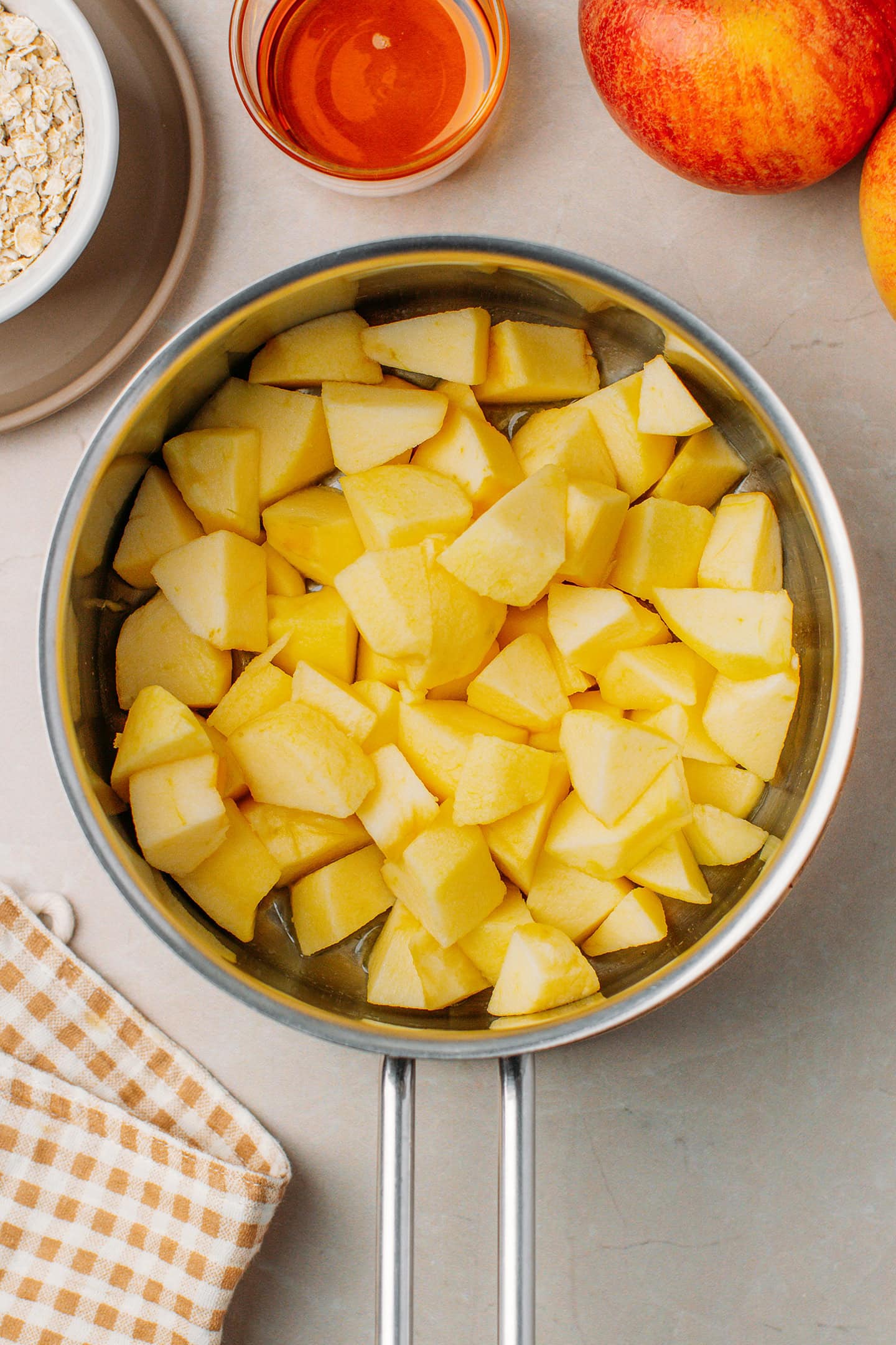 Diced apples and butter in a saucepan.