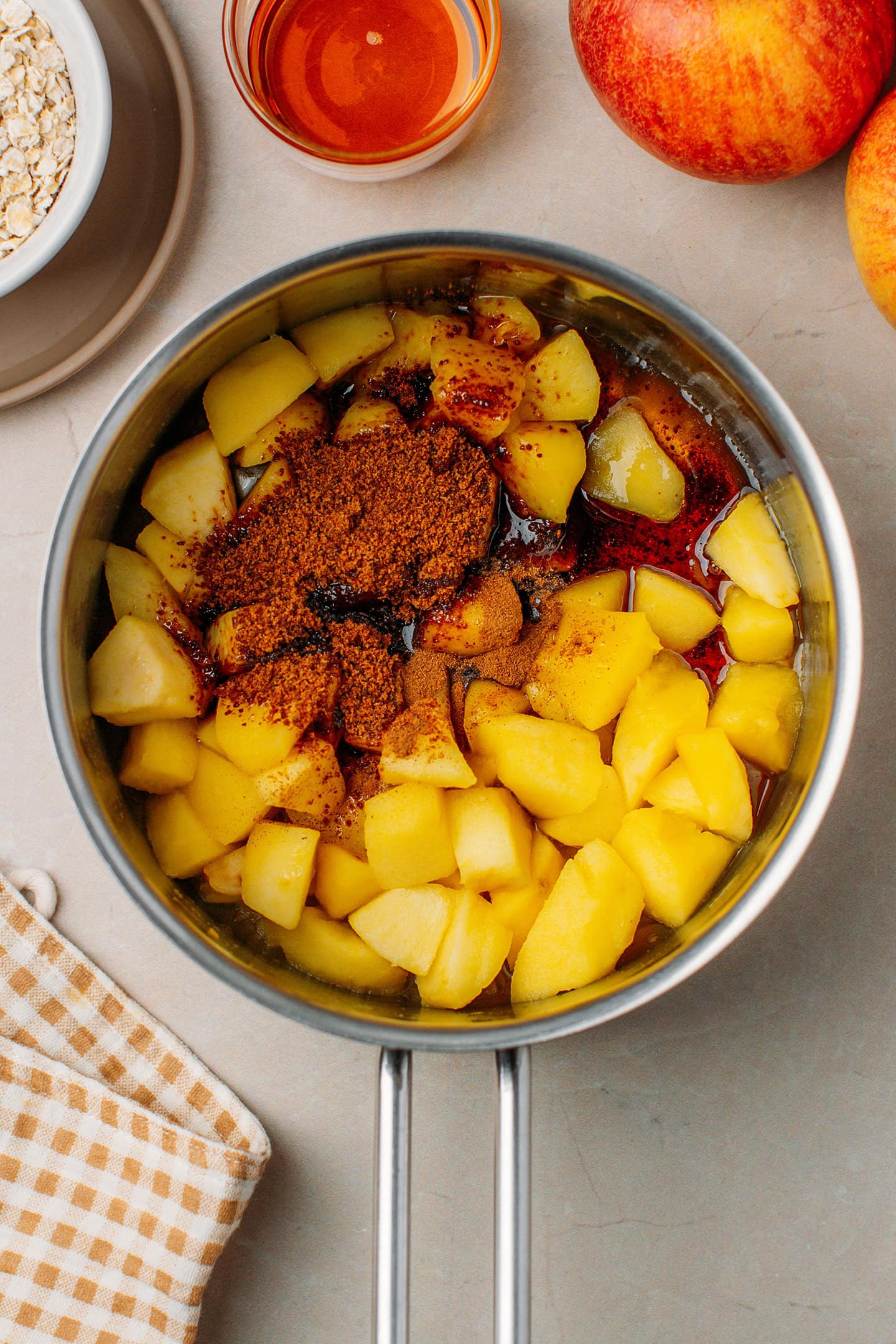 Saut&eacute;ed diced apples, coconut sugar, and maple syrup in a saucepan.