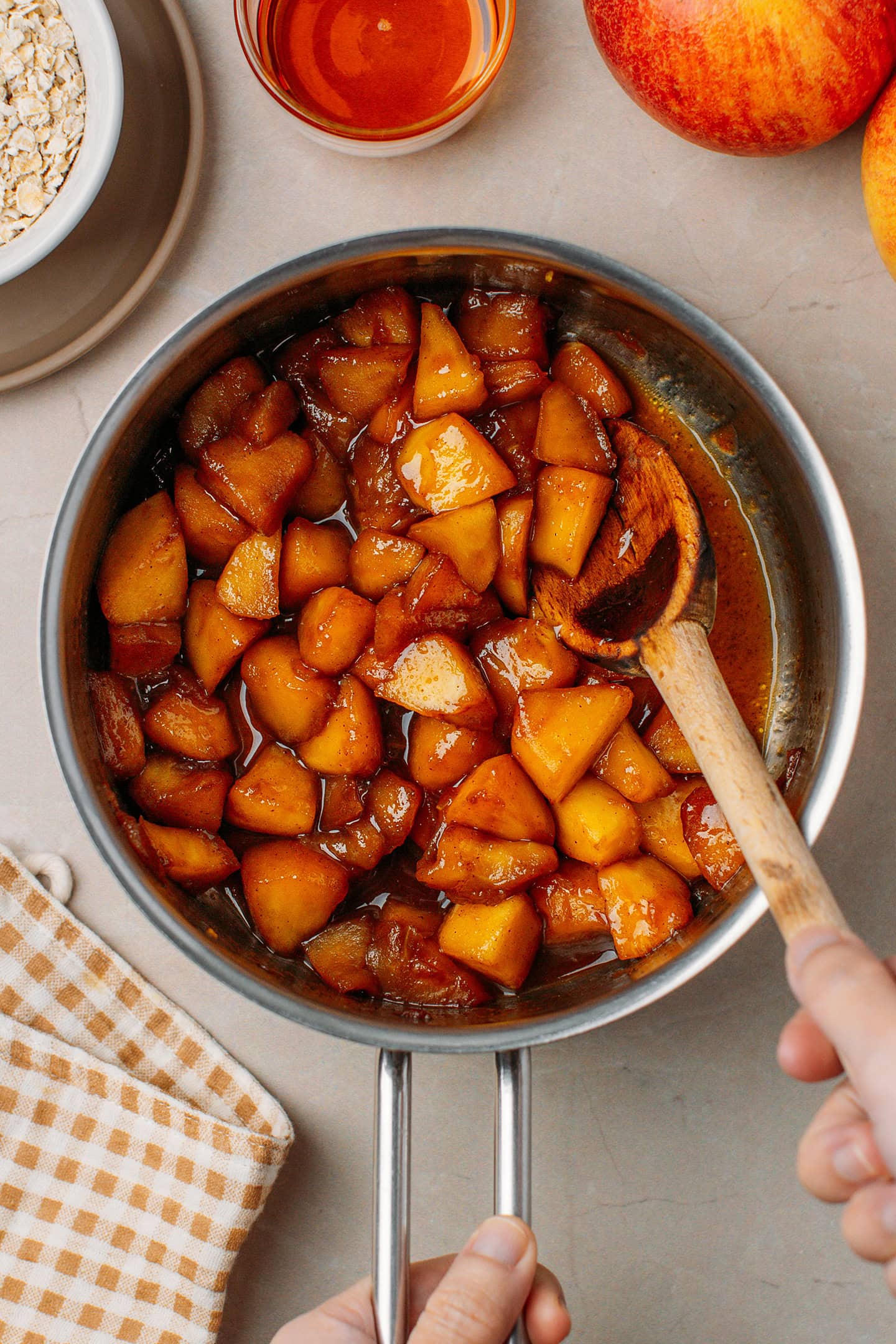 Gooey cinnamon apples in a saucepan.