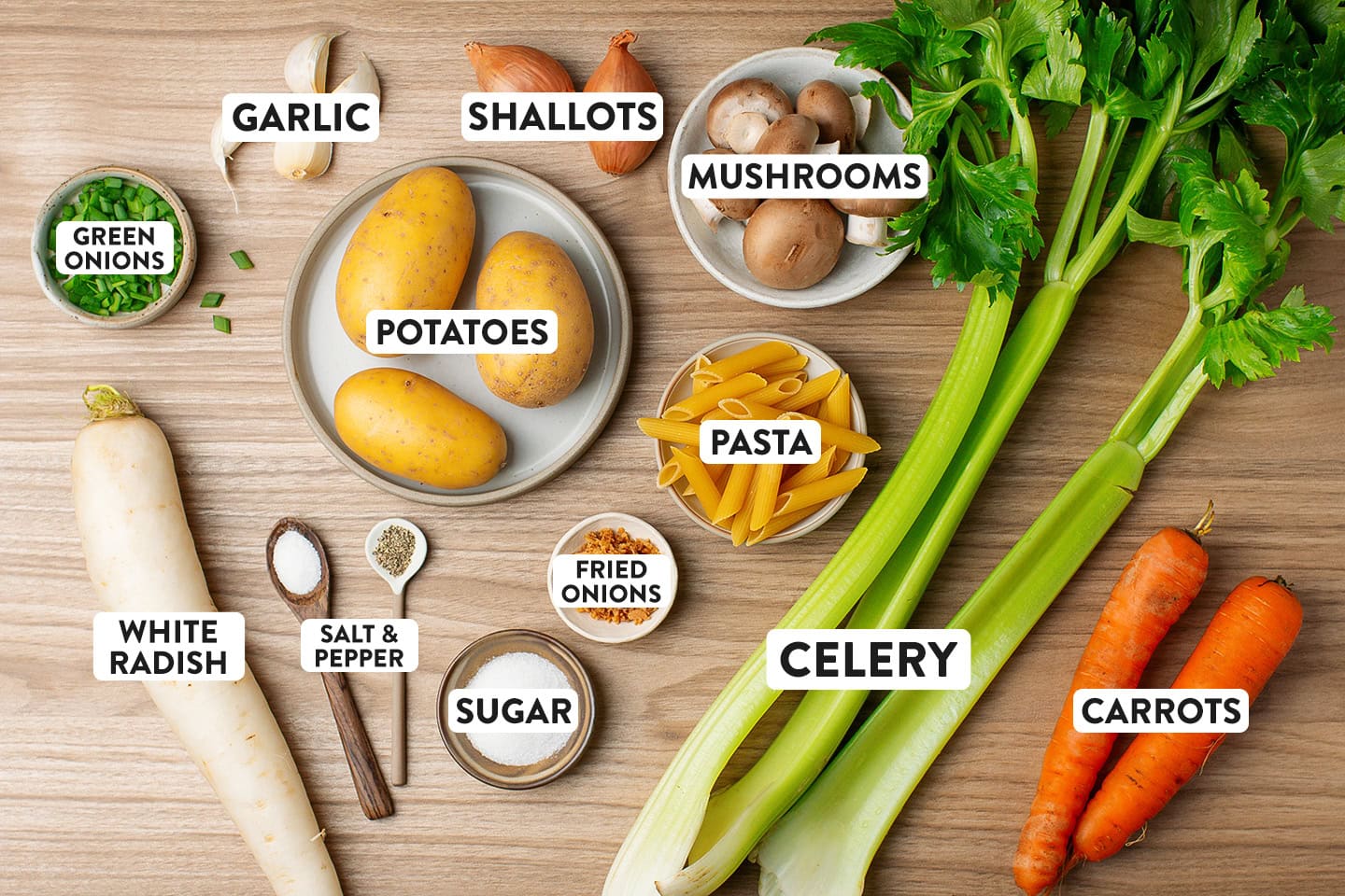 Ingredients like potatoes, celery stalks, carrots, radish, and pasta.